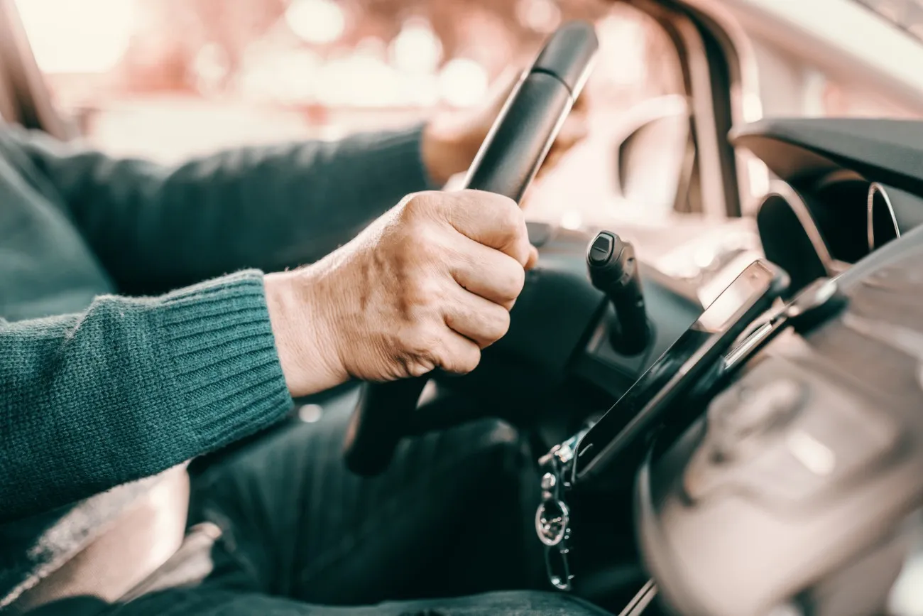 senior's hands on steering wheel