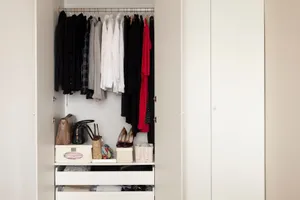 a neat and organized closet with clothes