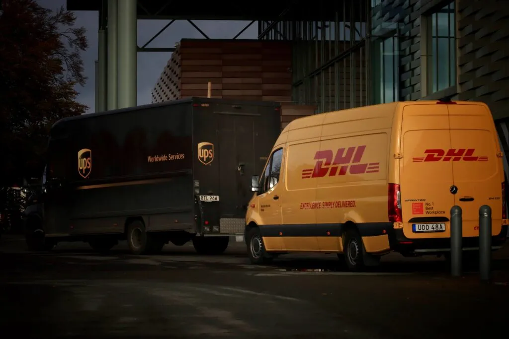 Delivery trucks lined up by building