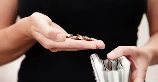 Woman Saving Money in Wallet