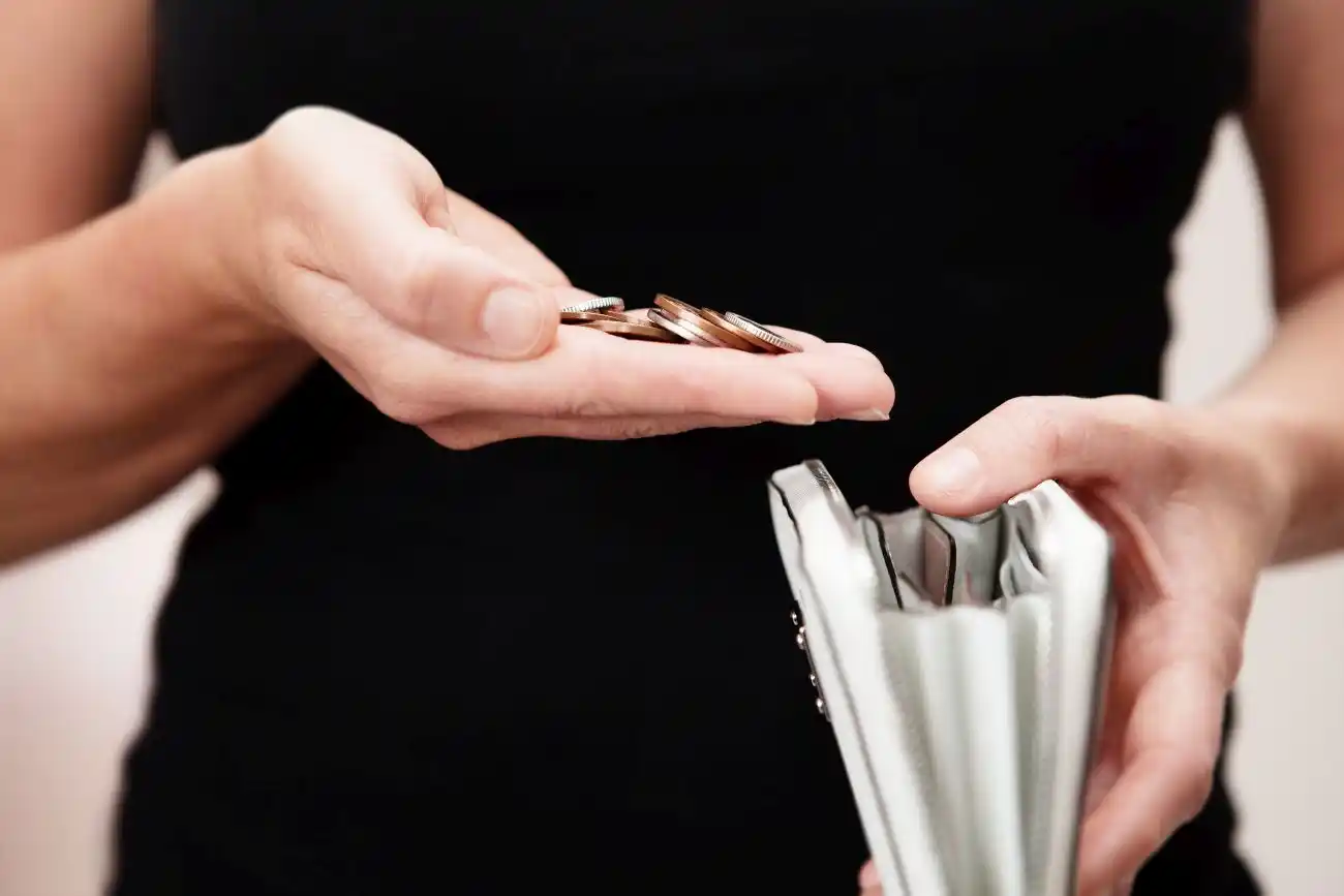 Woman Saving Money in Wallet