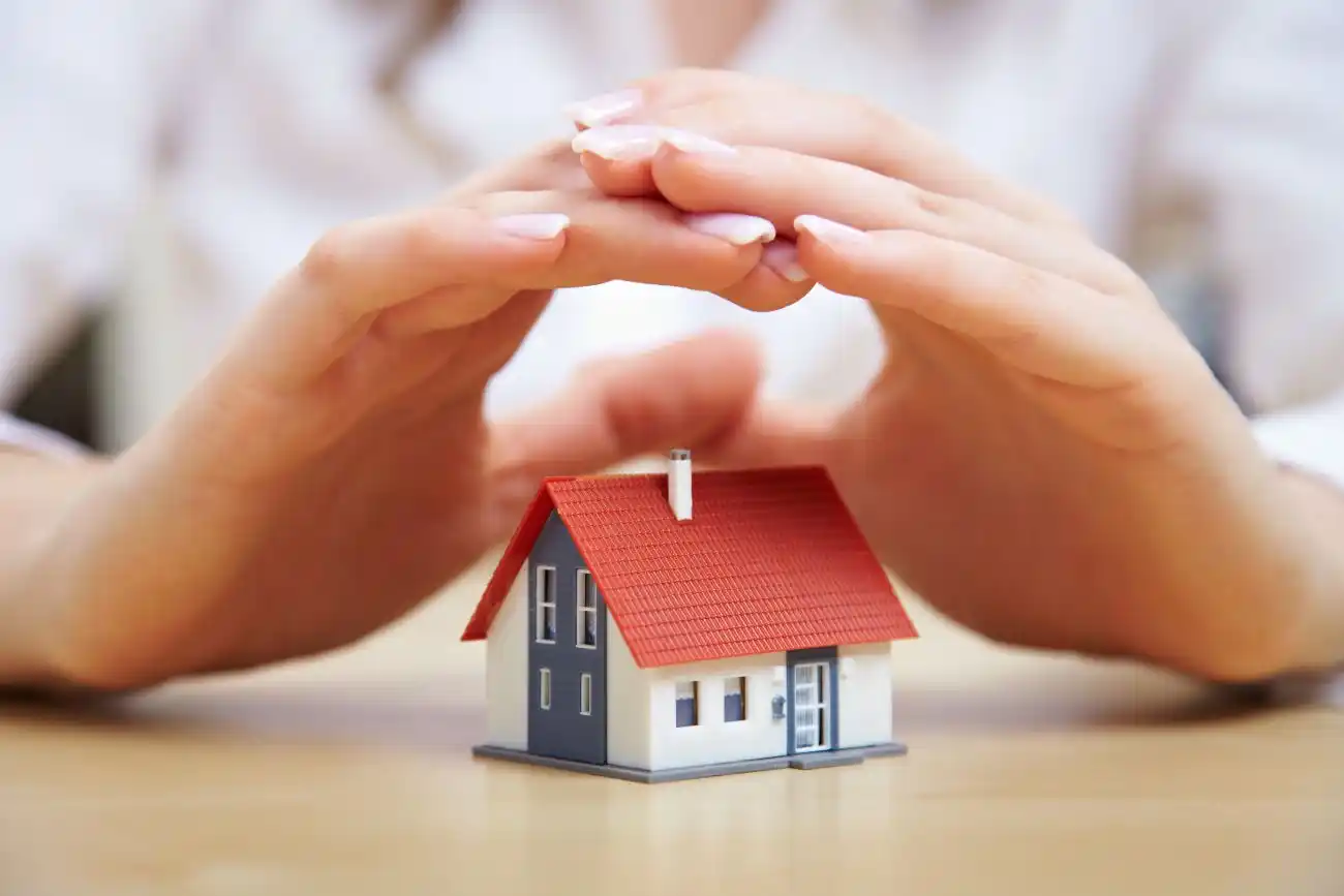 Womans Hands Covering Mini House