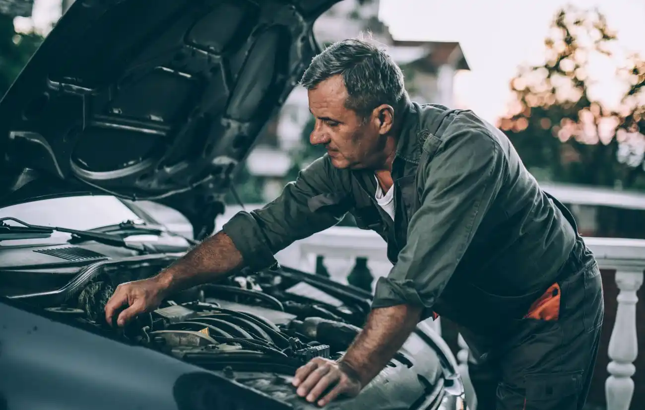 Man Working on His Own Car Engine