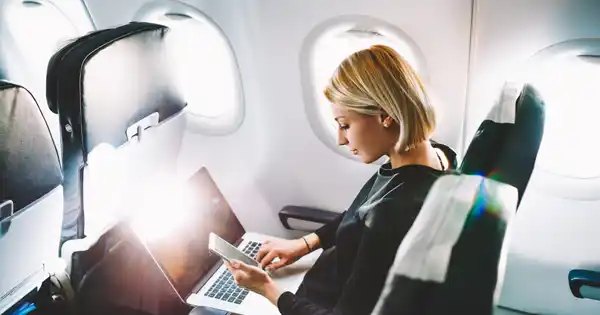 Woman Working on Computer on a Plane