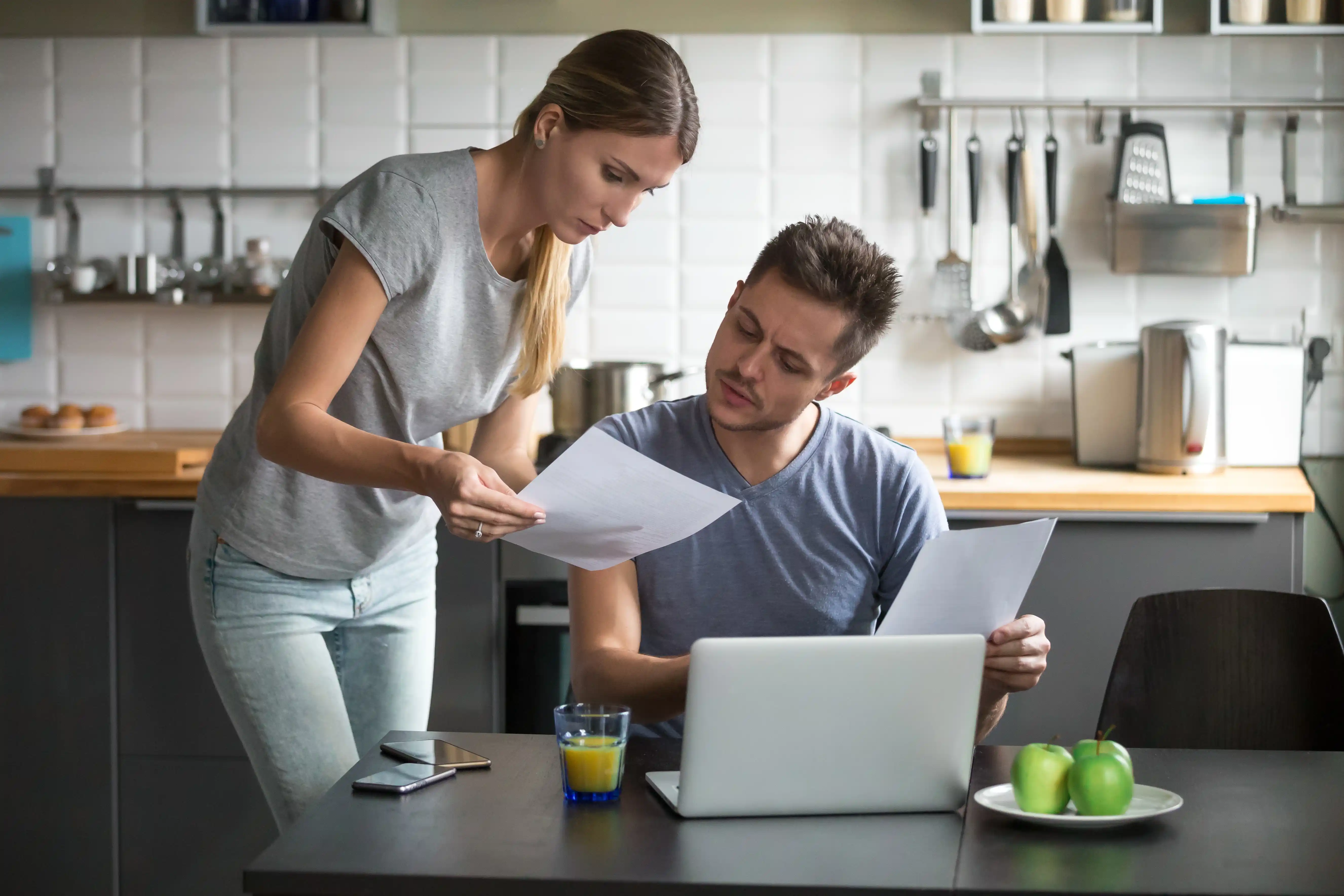 Roommates Discussing Rent in Kitchen