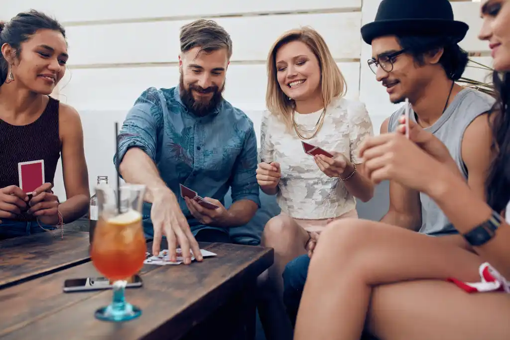 Friends Staying In Having Fun Playing Cards