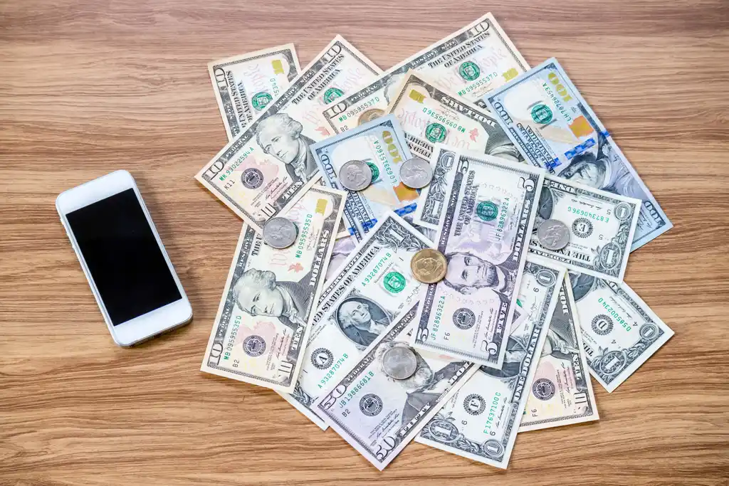 Cash Money on Table by Mobile Phone