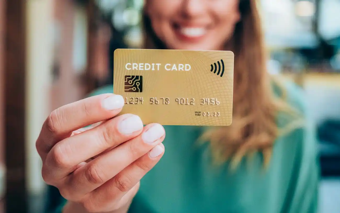 Woman Holding Gold Credit Card
