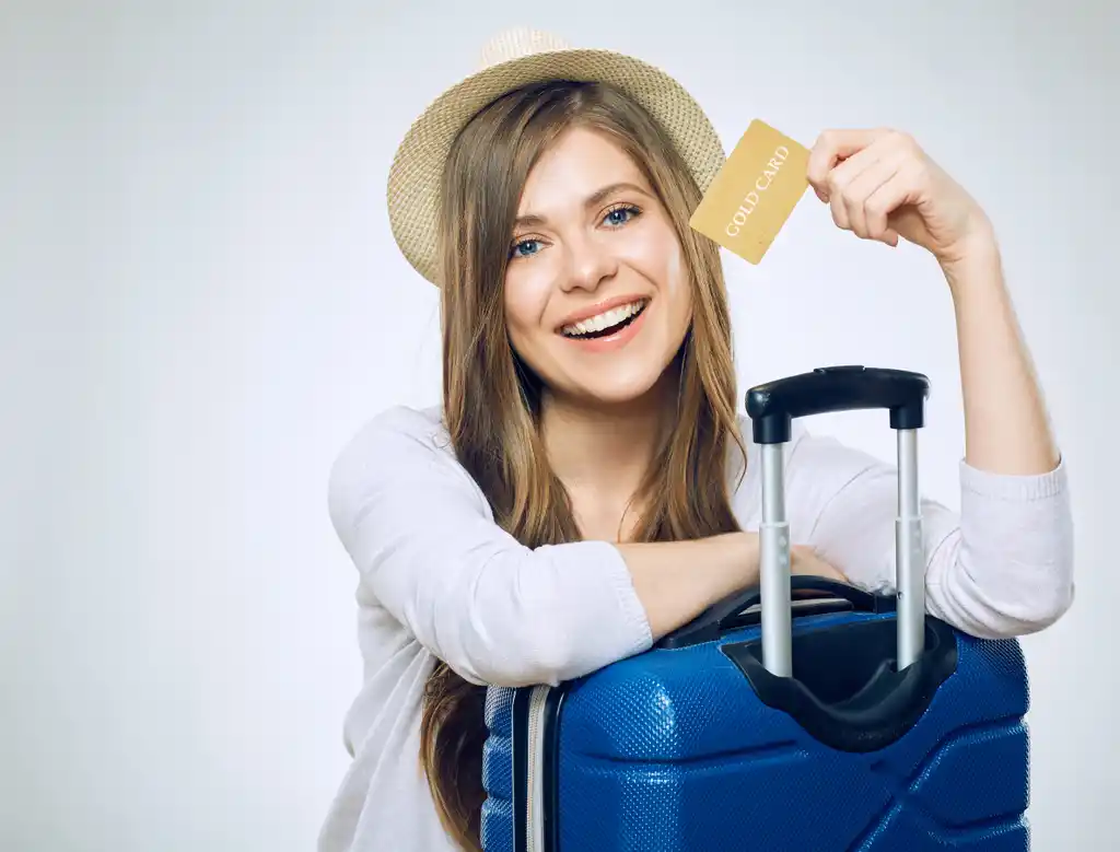 Woman with Credit Card and Travel Luggage