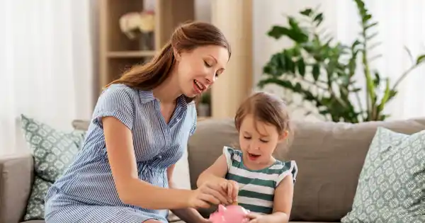 Single Mom and Child Putting Money in Piggy Bank
