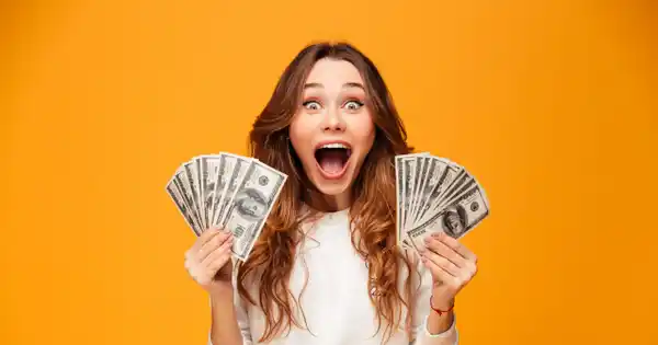 Woman Excited with Hands Full of Cash
