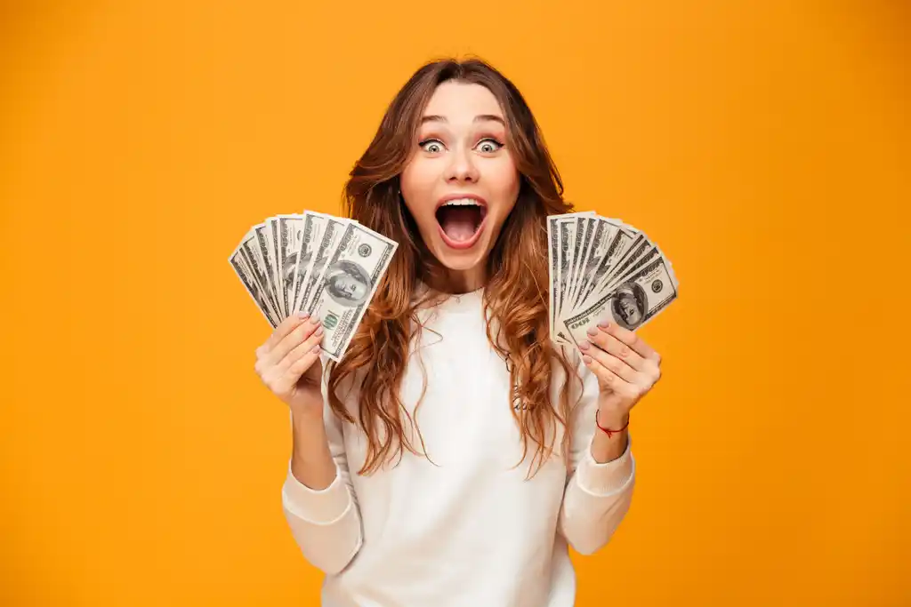 Woman Excited with Hands Full of Cash