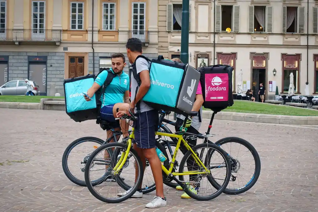 Gig Workers Looking at Phone on Delivery Bike