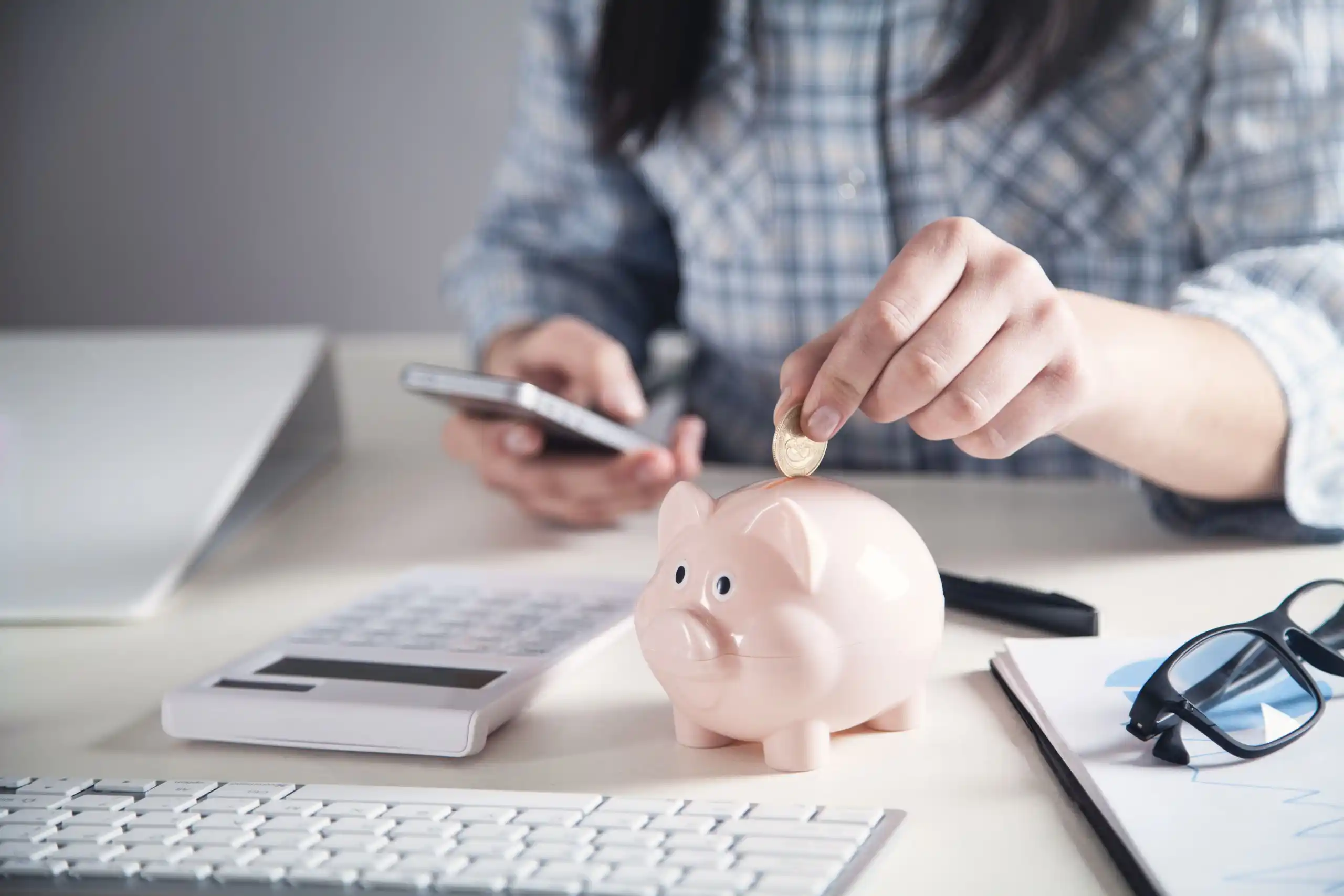 Man Putting Coin in Piggy Bank