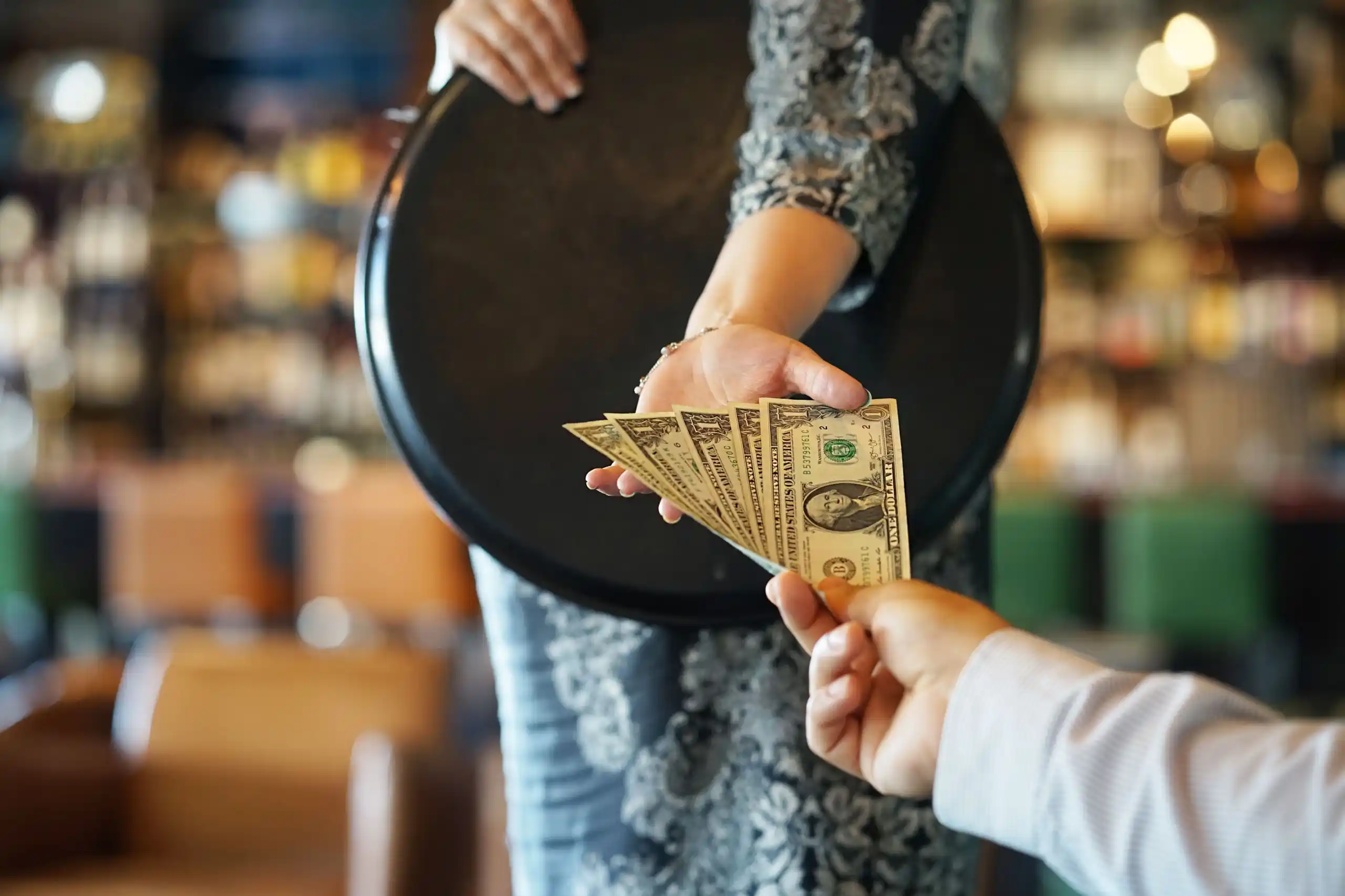 Customer Tipping Waiter in Restaurant