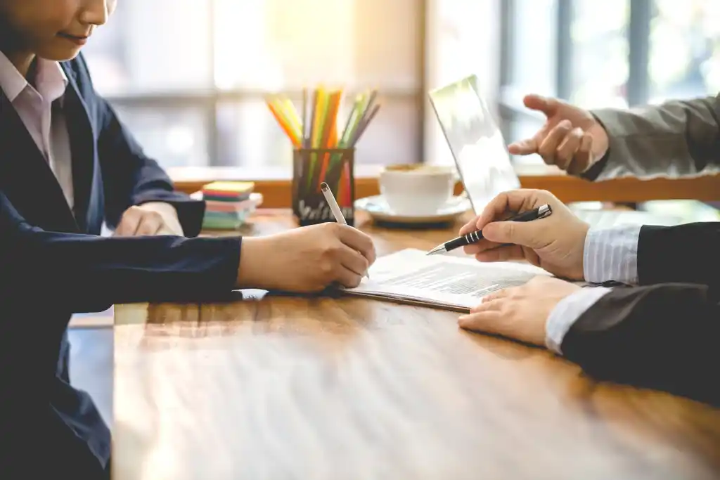 Woman Co-Signing a Loan in Office