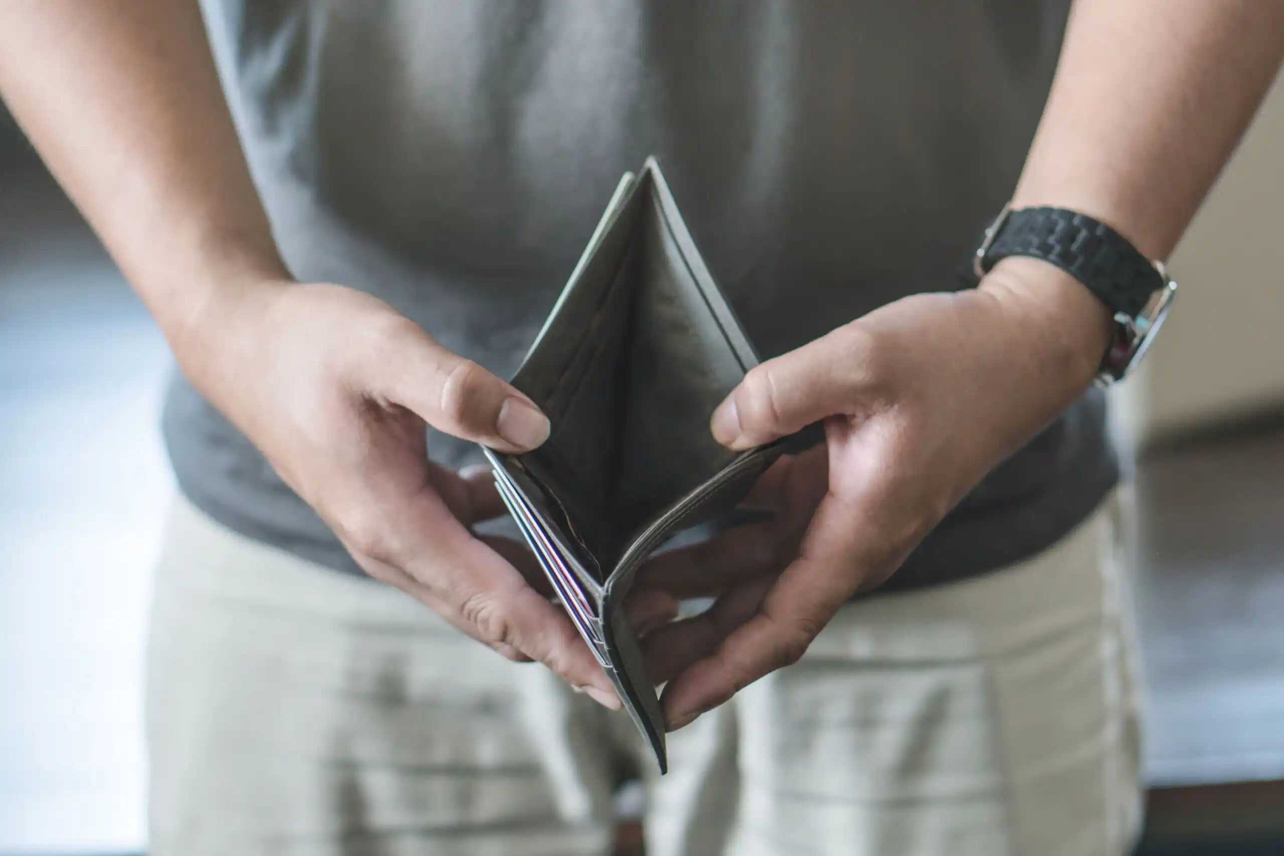 Man Opening Empty Wallet