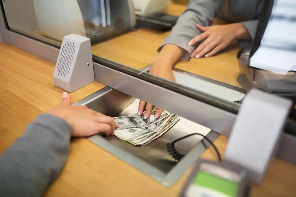 Woman Borrowing Money From Bank Teller