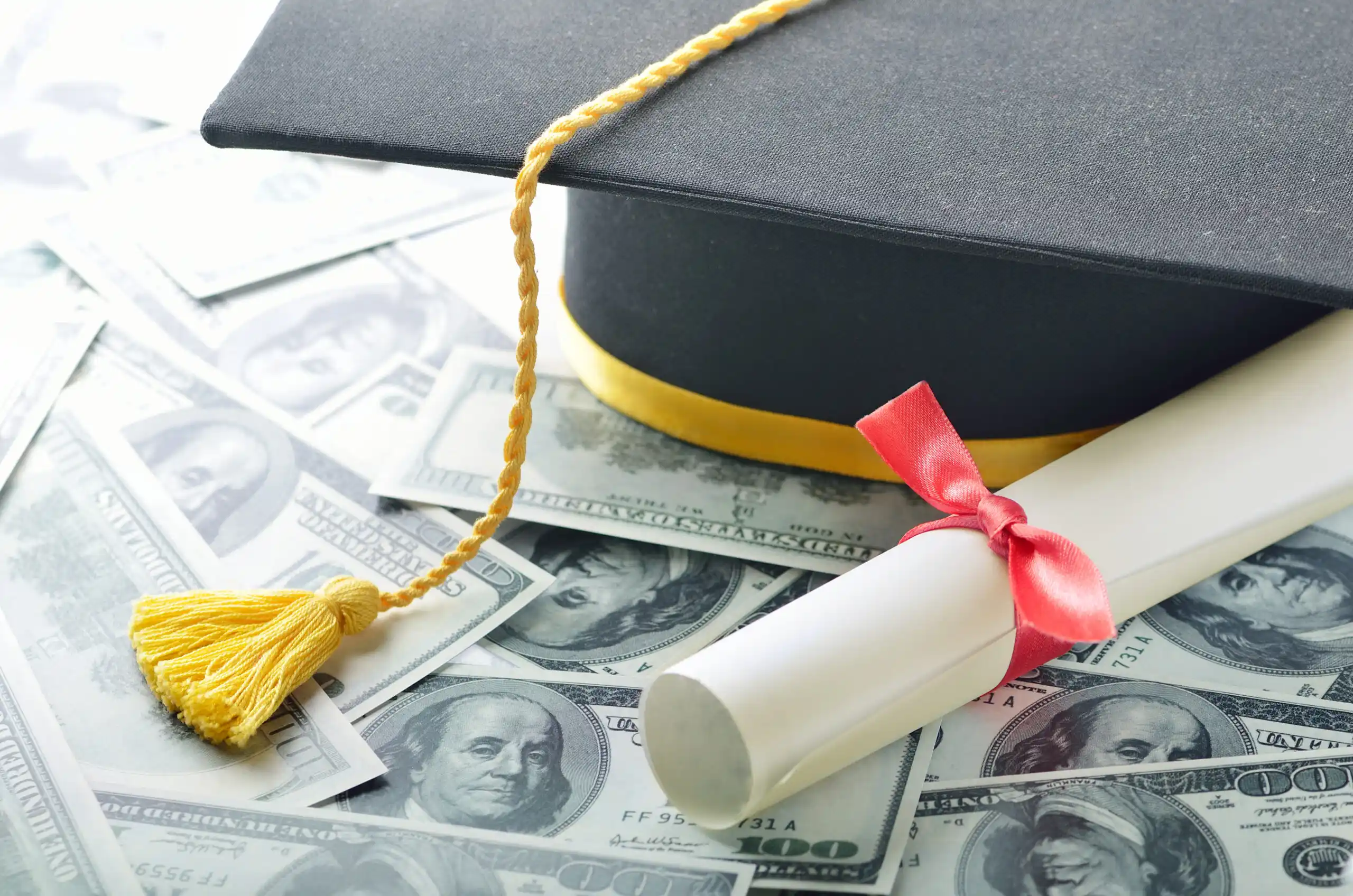 Student Graduation Cap on Top of Money