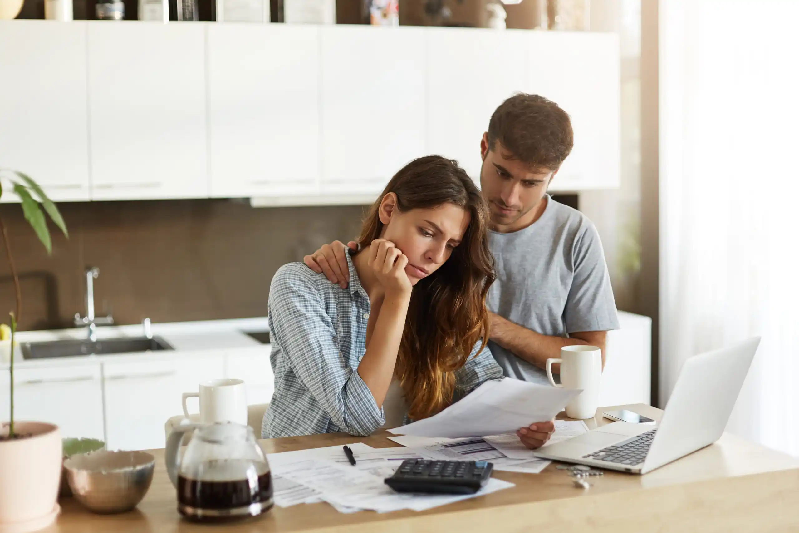 Couple Considering Debt in Kitchen