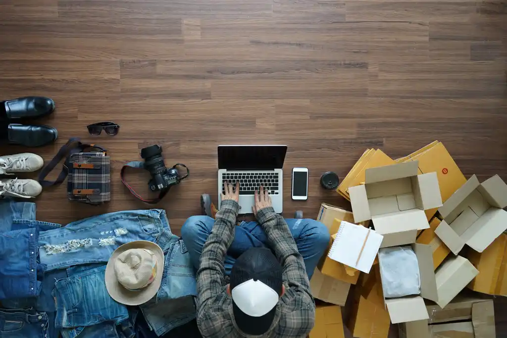 Man Shopping Online Surrounded by Open Deliveries