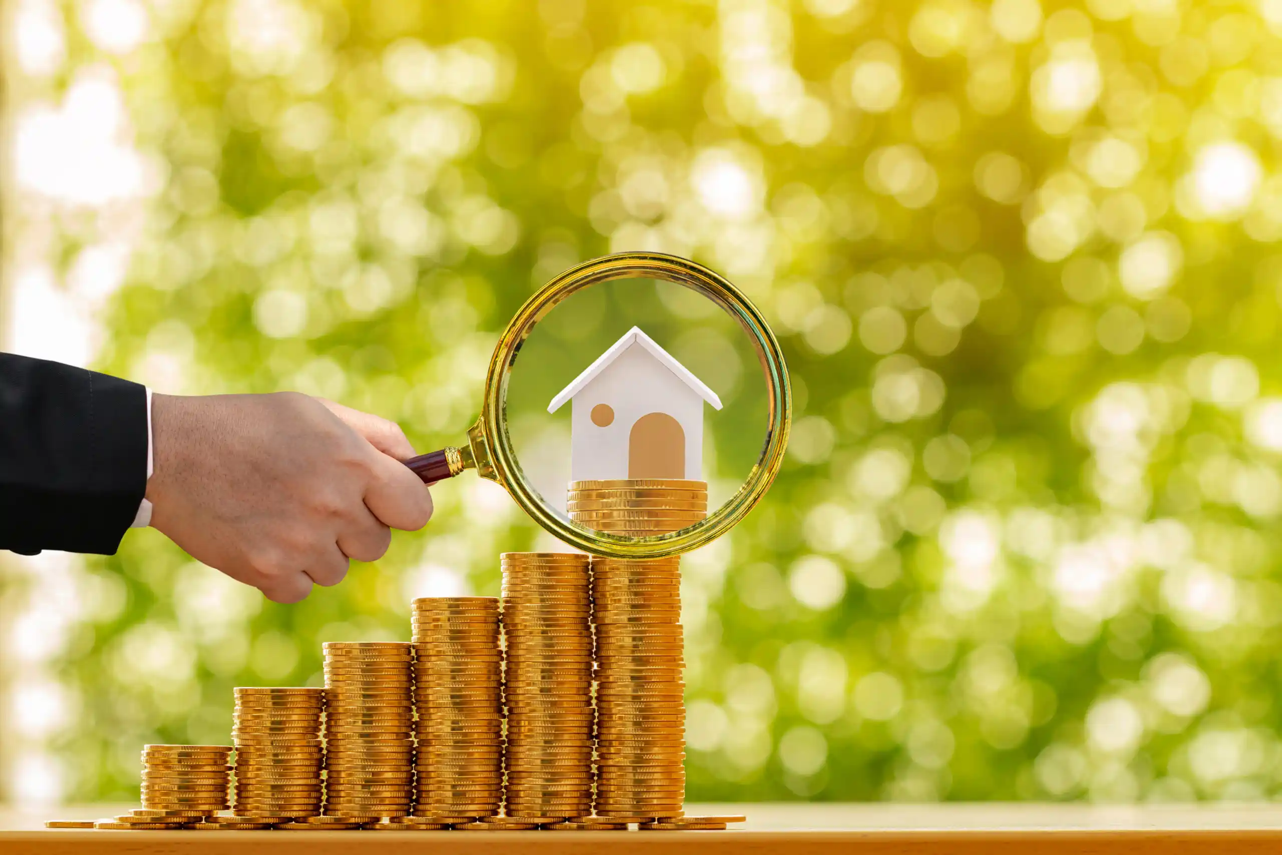 Gold Stack of Coins with Mini House on Top