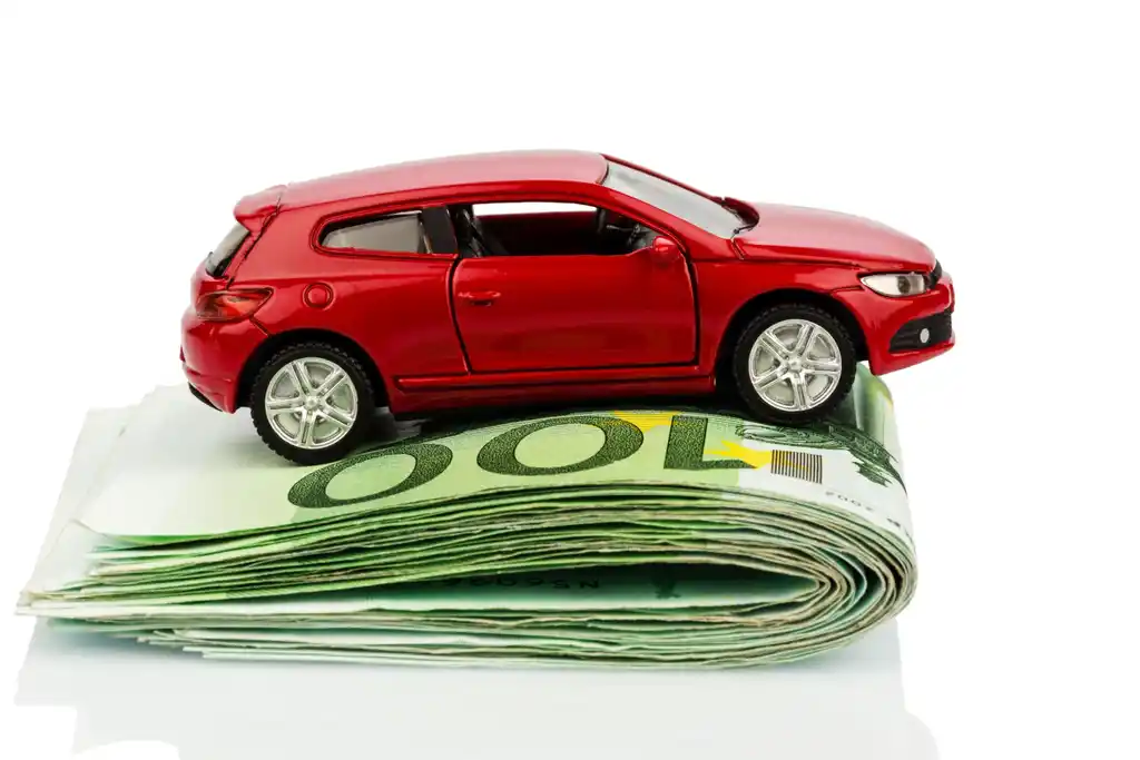 Red Toy Car on Folded Cash