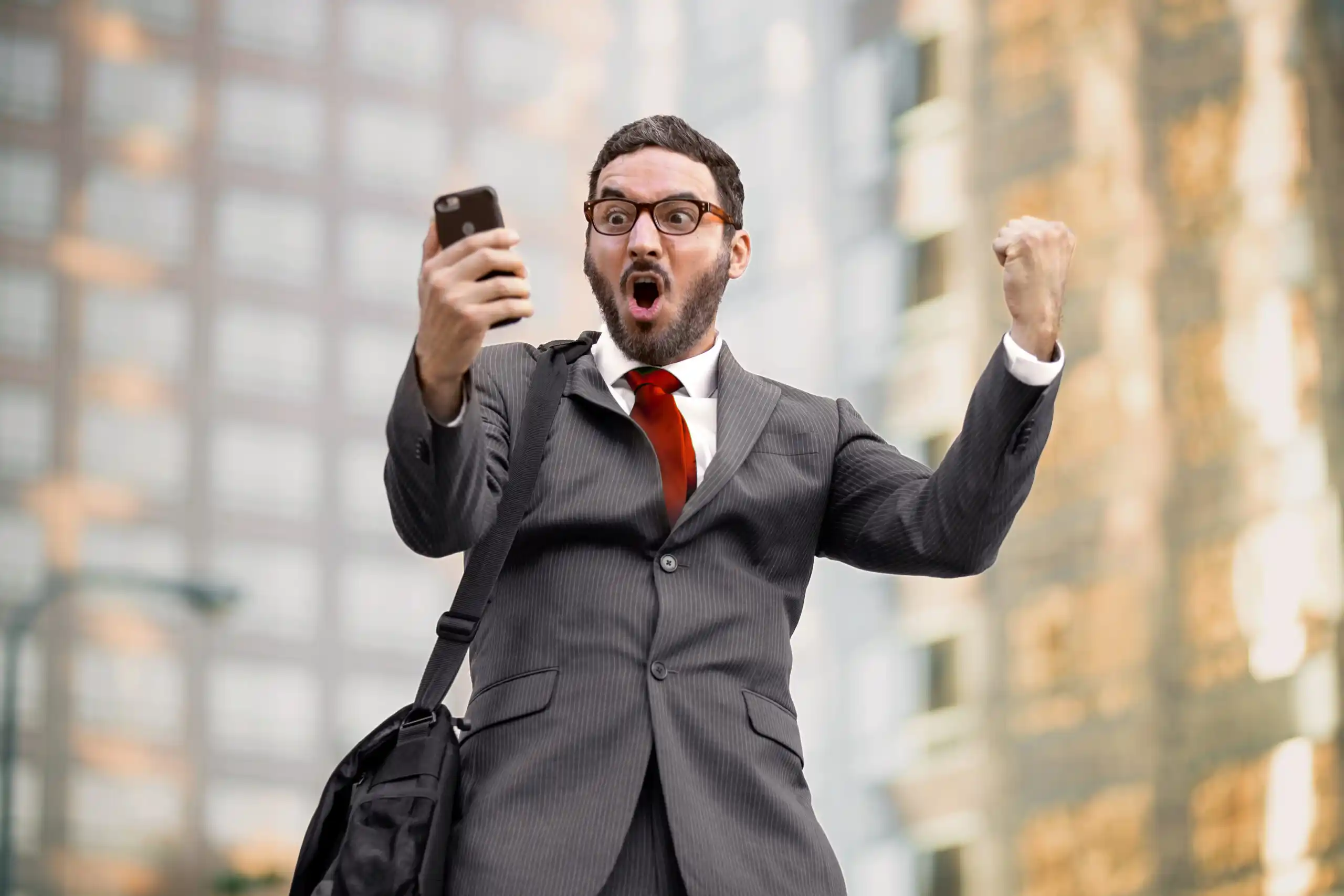 Investor Celebrating Looking at Mobile Phone