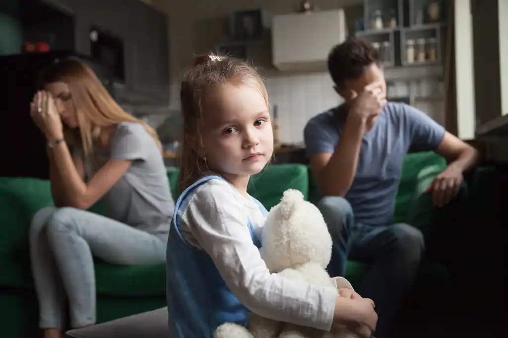 Child Sad with Parents Fighting in Background