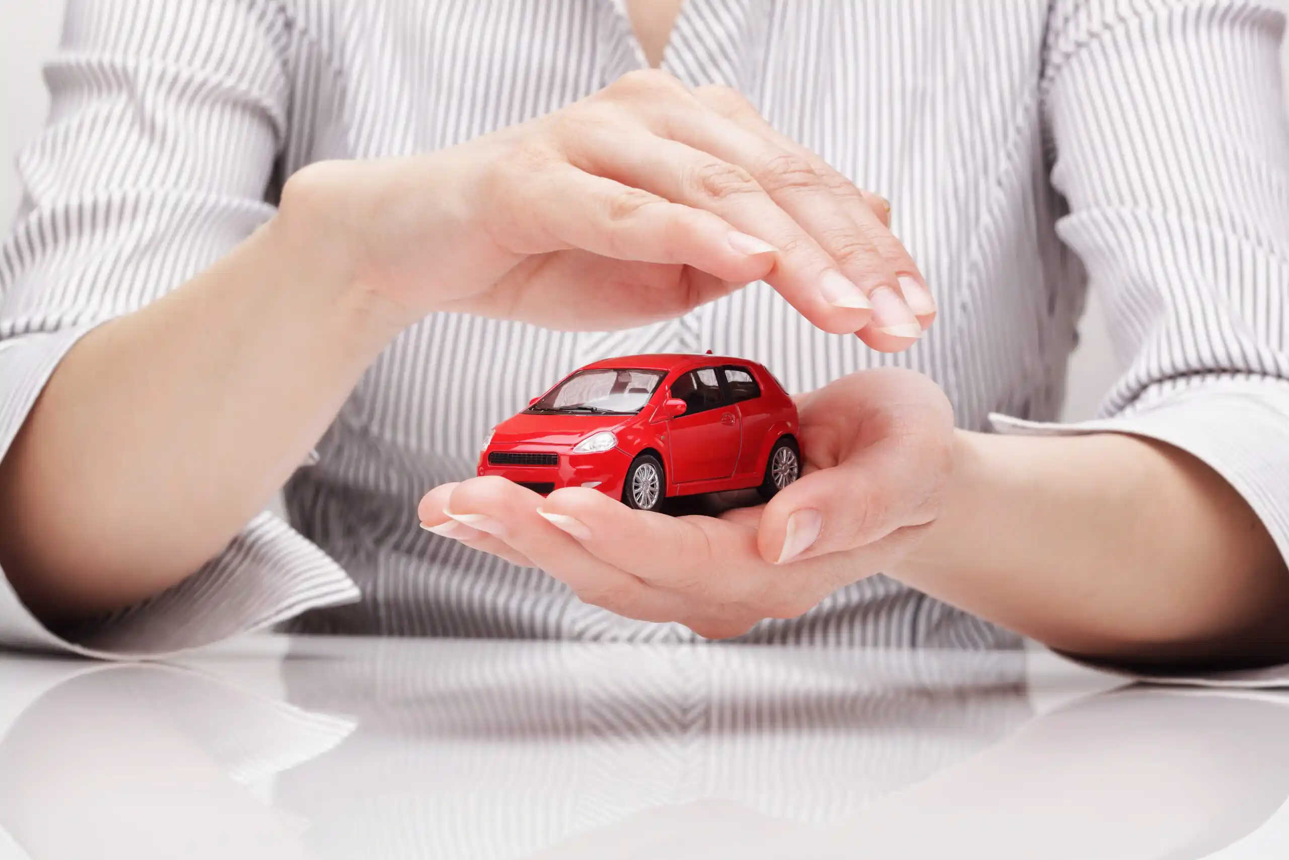 Woman Holding Mini Red Car