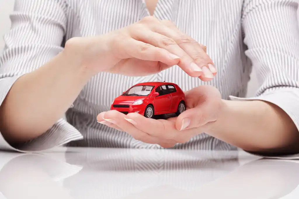 Woman Holding Mini Red Car