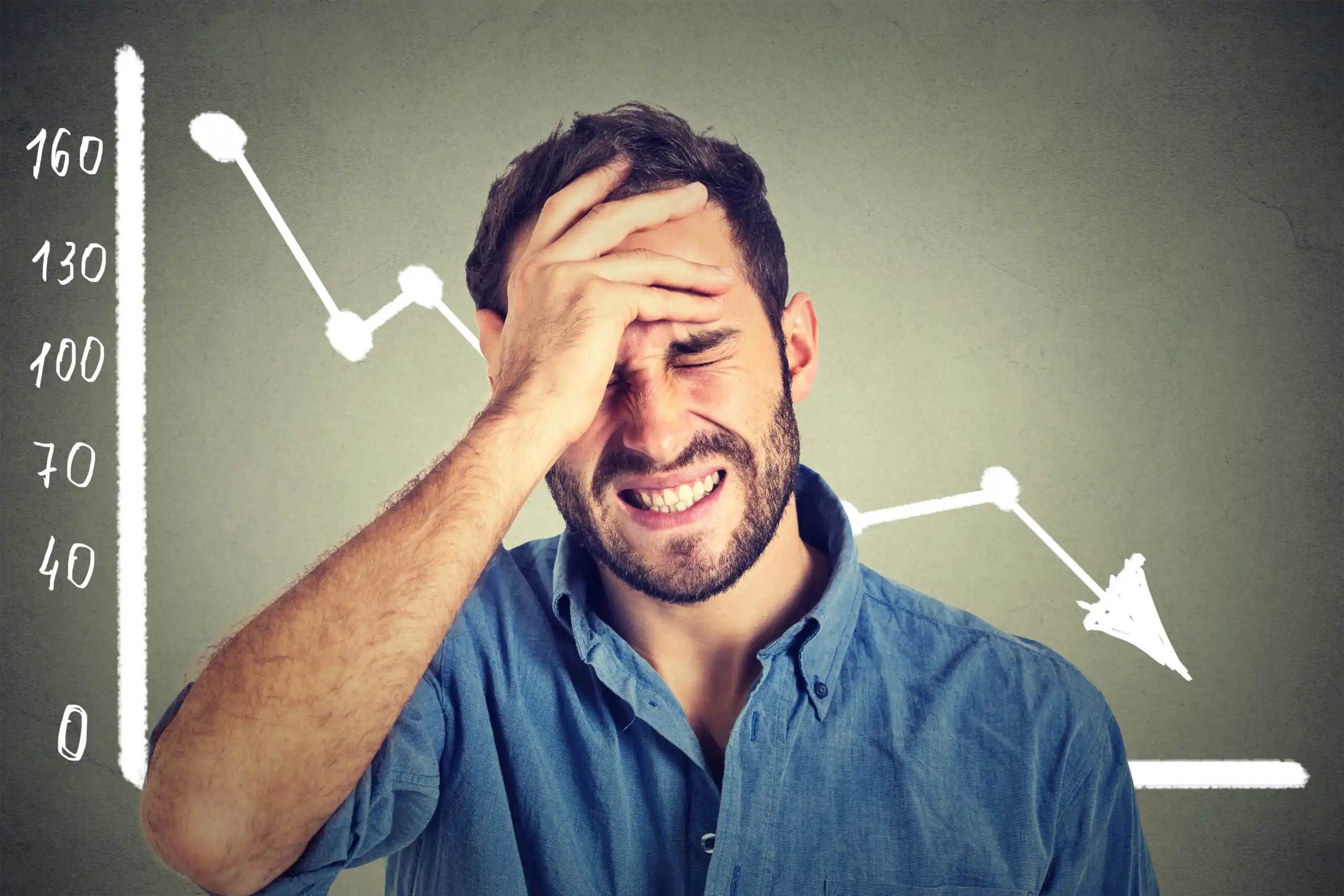 Man Upset with Financial Decline Chart Behind Him