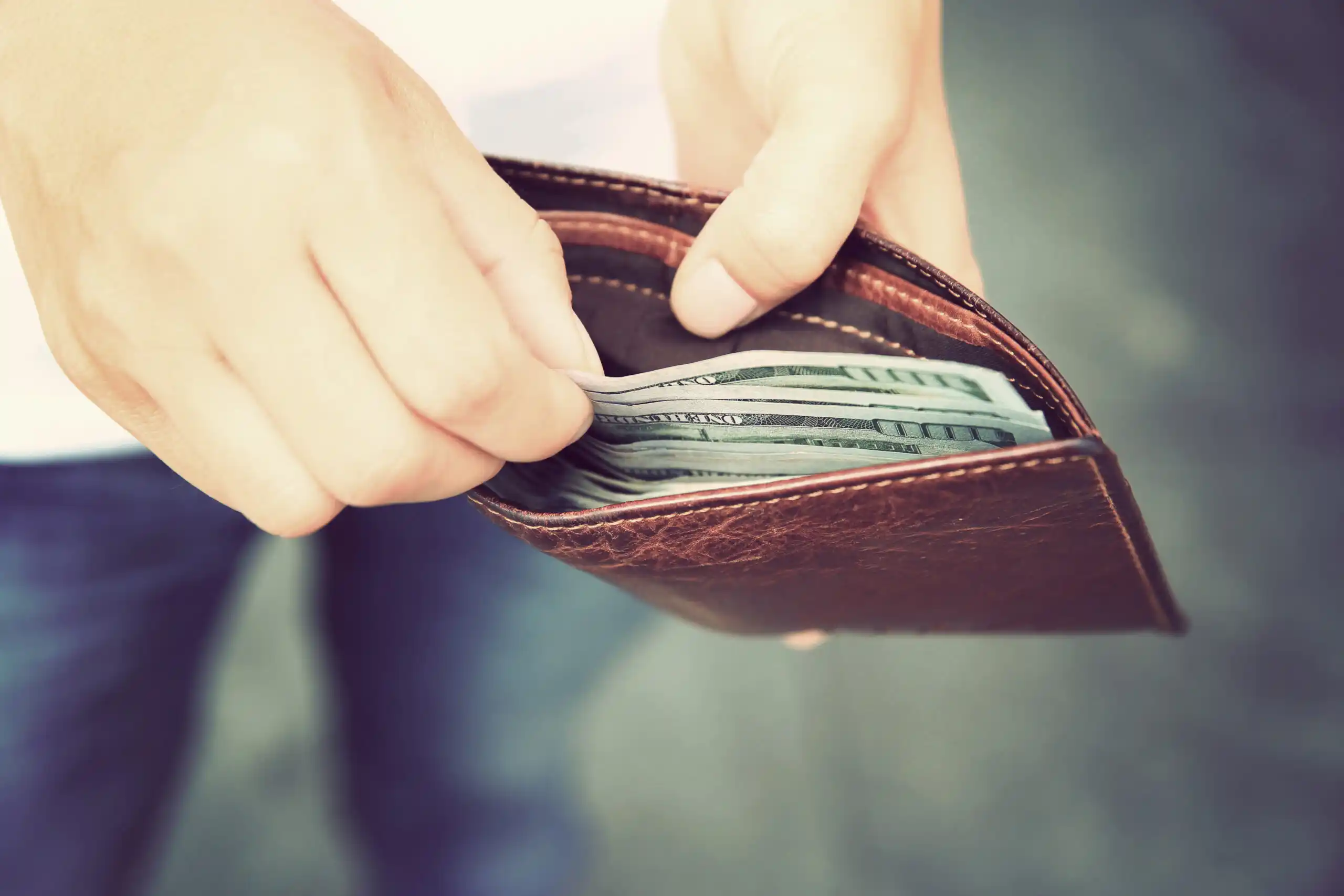 Man Pulling Money Out of Wallet