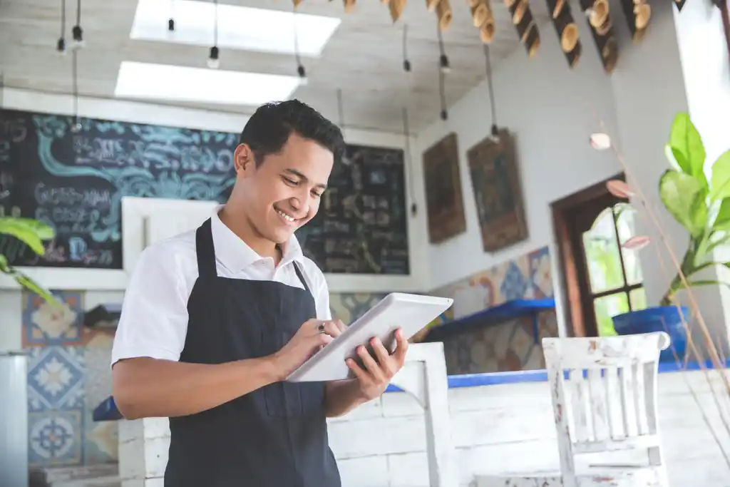 Small Business Owner Smiling at Tablet