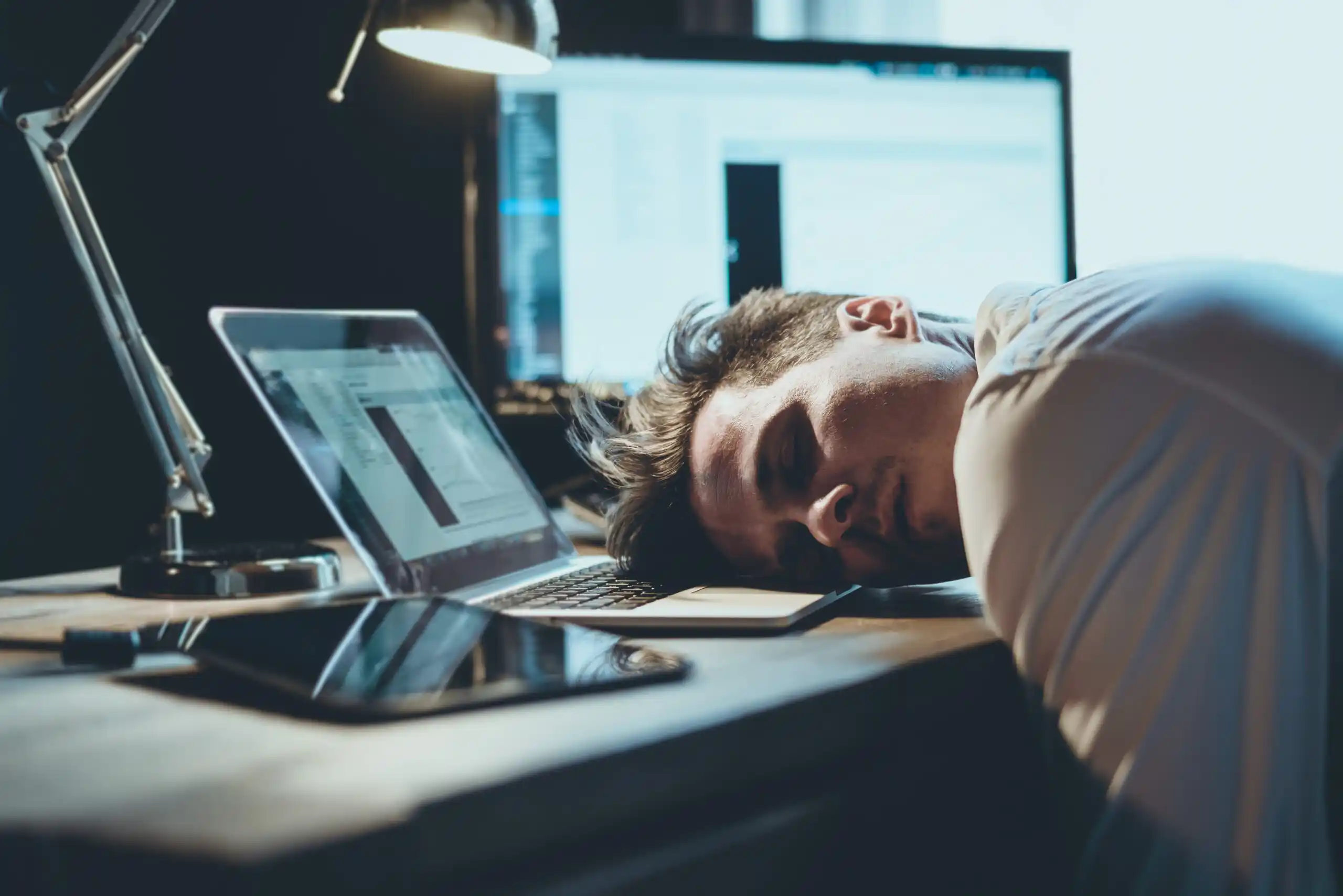 Man Sleeping on Laptop at Work