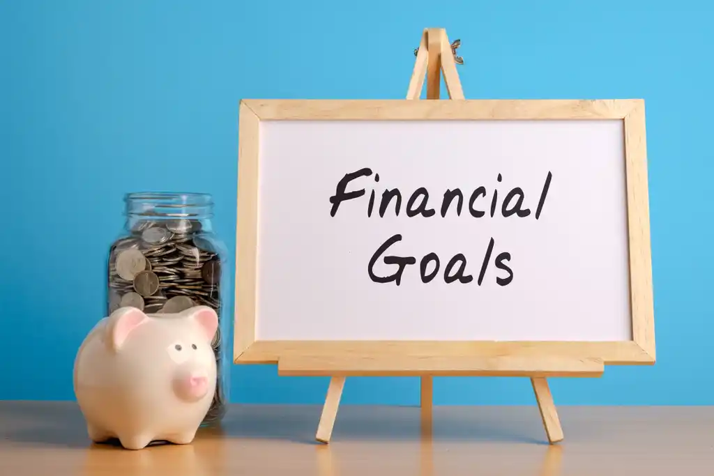 Financial Goals Whiteboard with Coin Jar and Piggy Bank