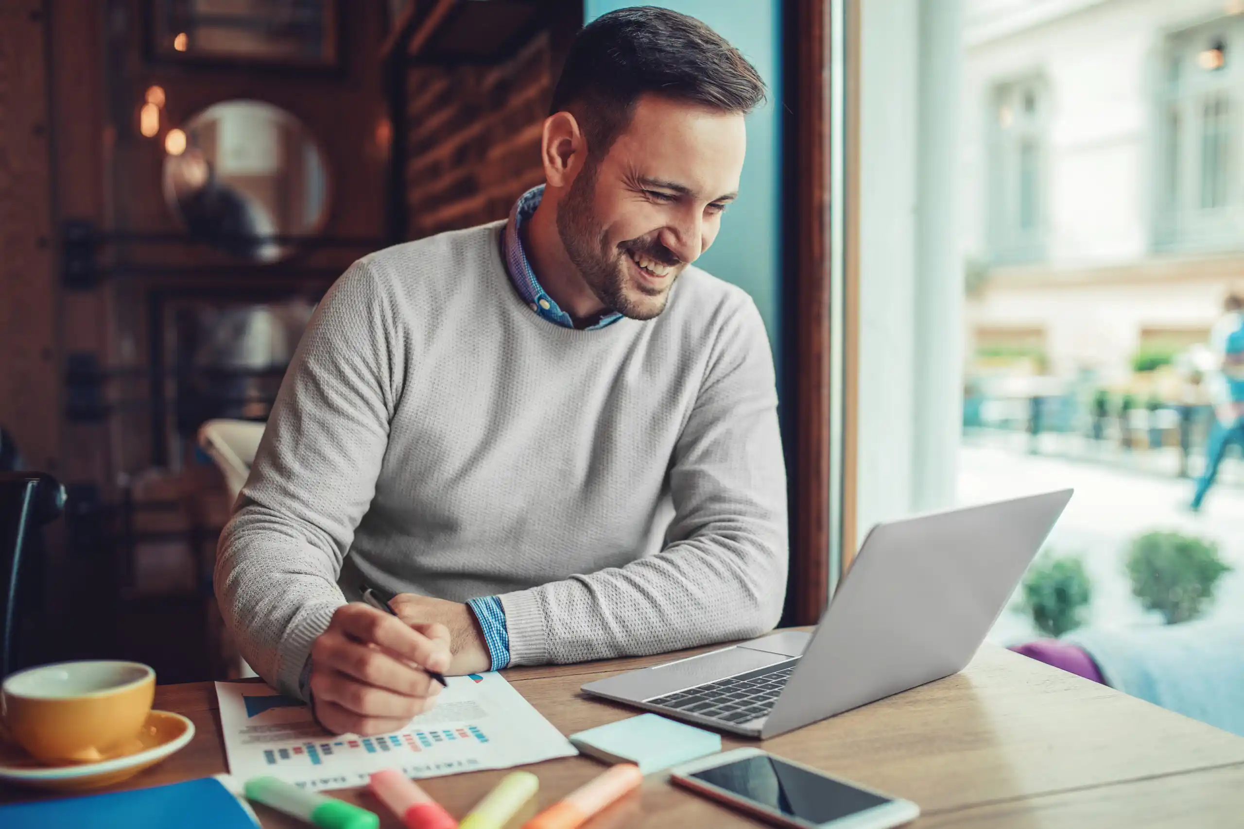 Man Working on Laptop at Coffee Shop