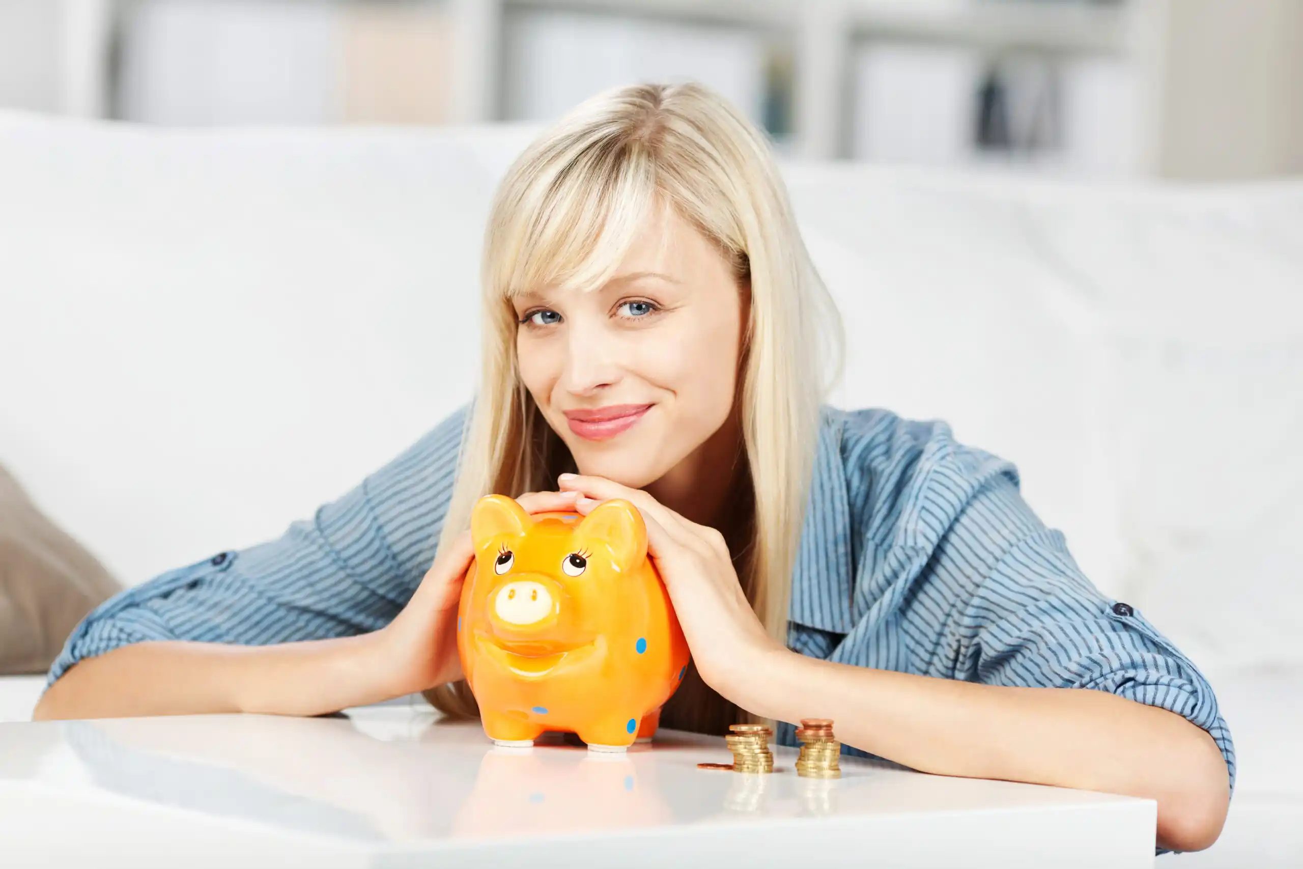 Woman Smiling Holding Piggy Bank