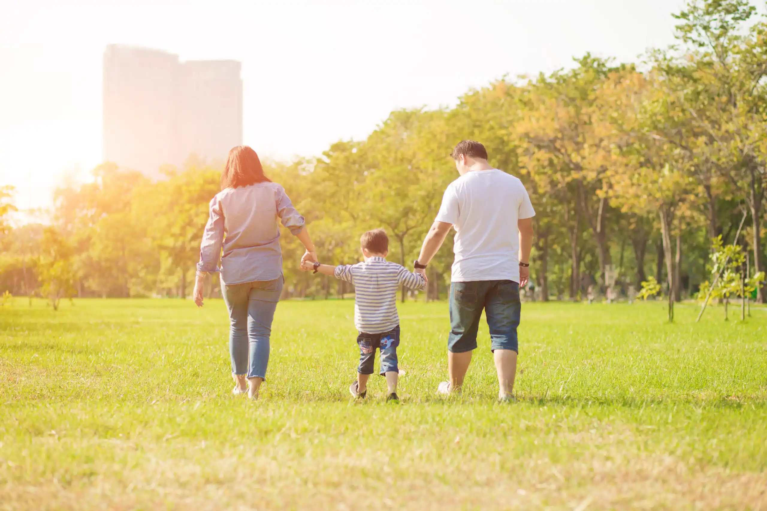 Two Parents Playing Outside with Child