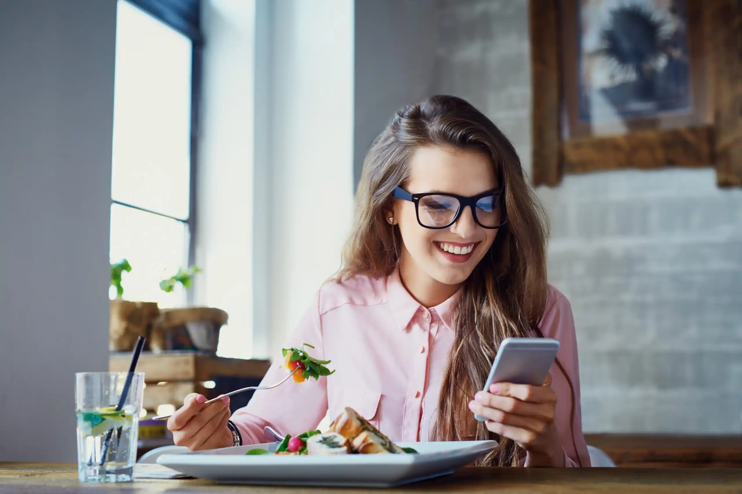 Woman eating healthy and checking her bank balance