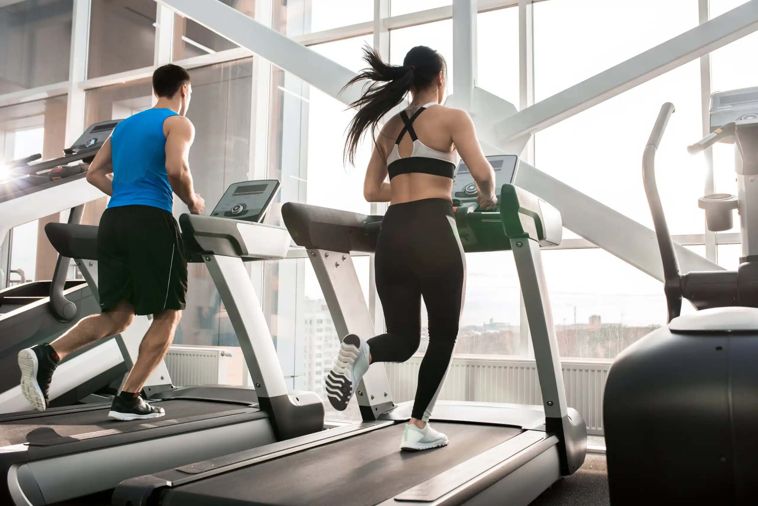 Gym Members Running on Treadmill