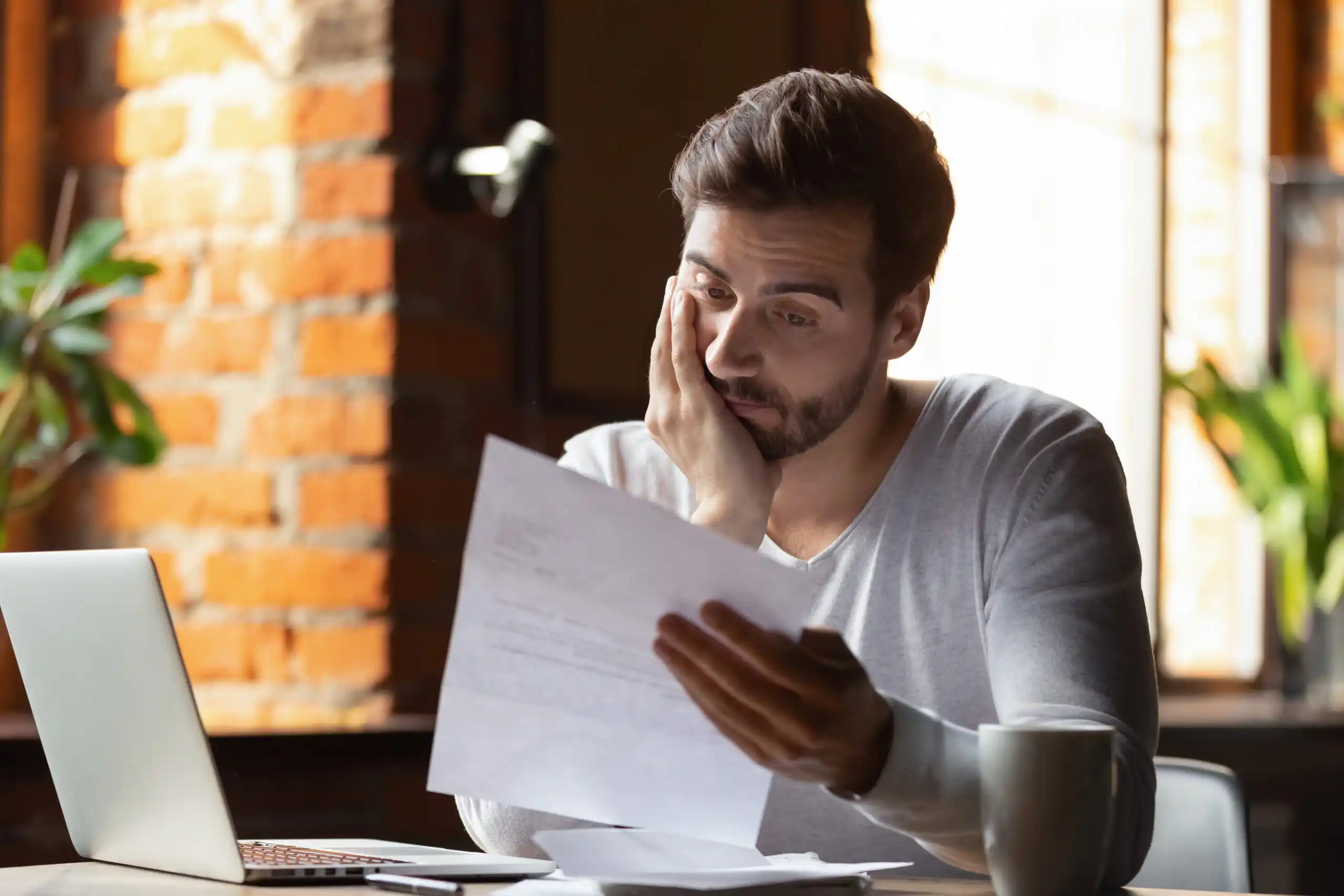 Man looks at Student Loan Notice
