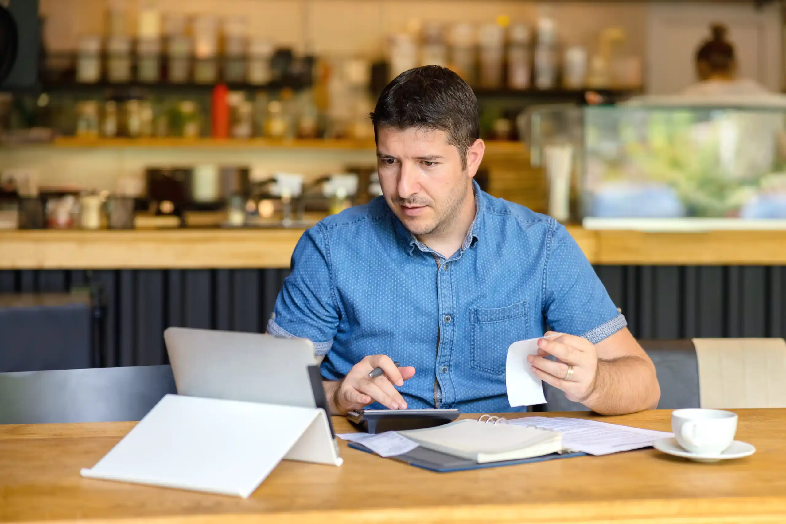 Restaurant owner calculating backup withholding