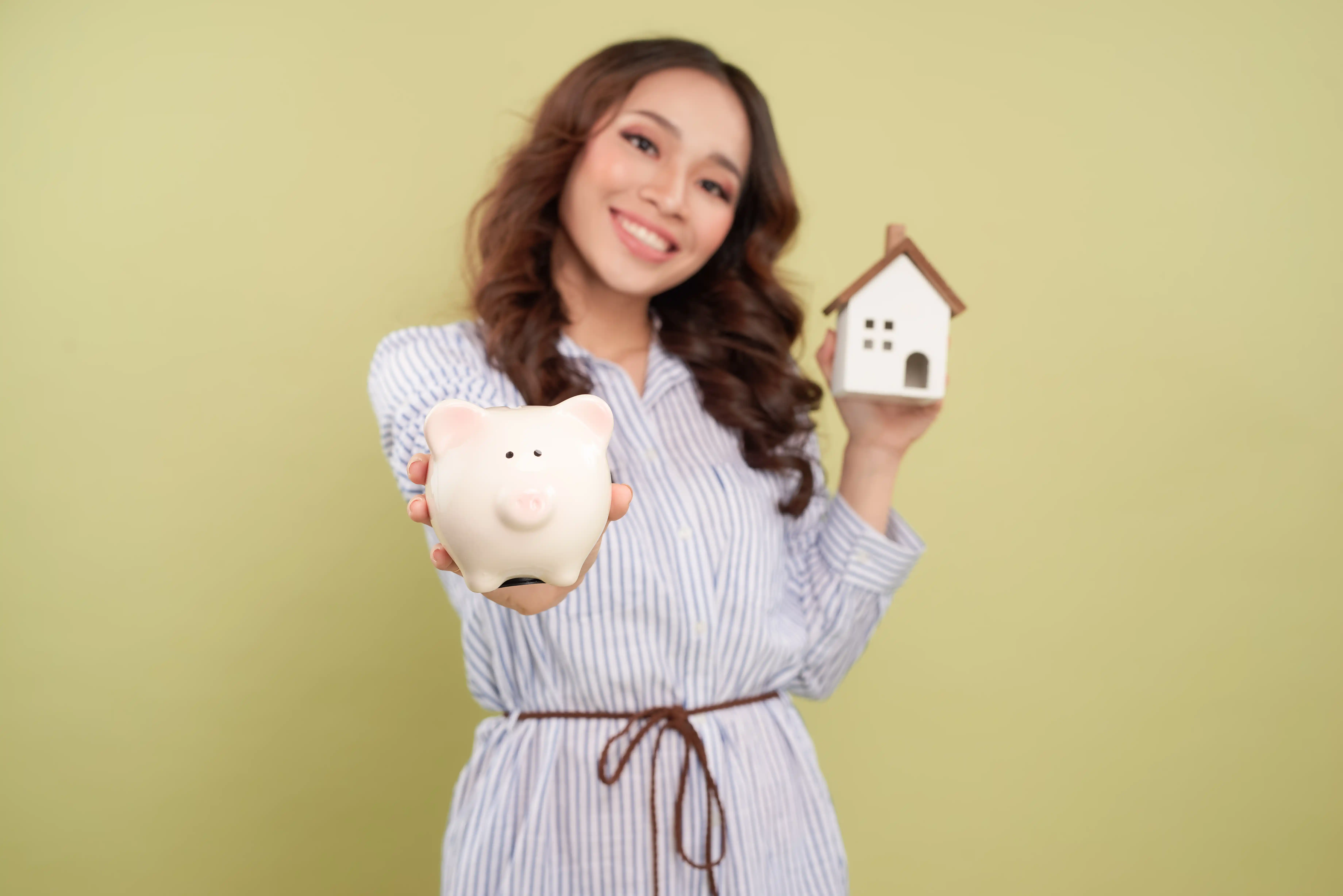 woman holding bank and house closing costs