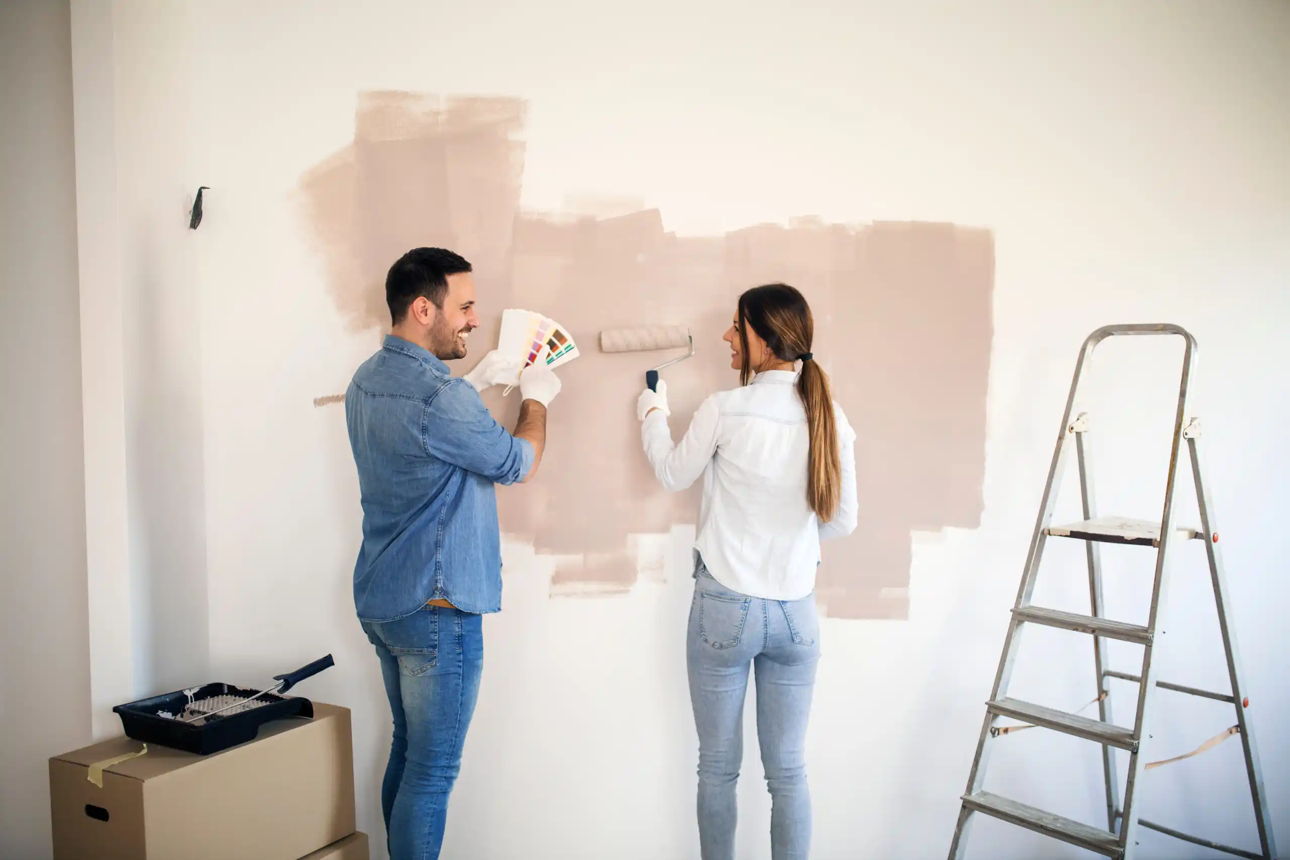young couple redecorating a house
