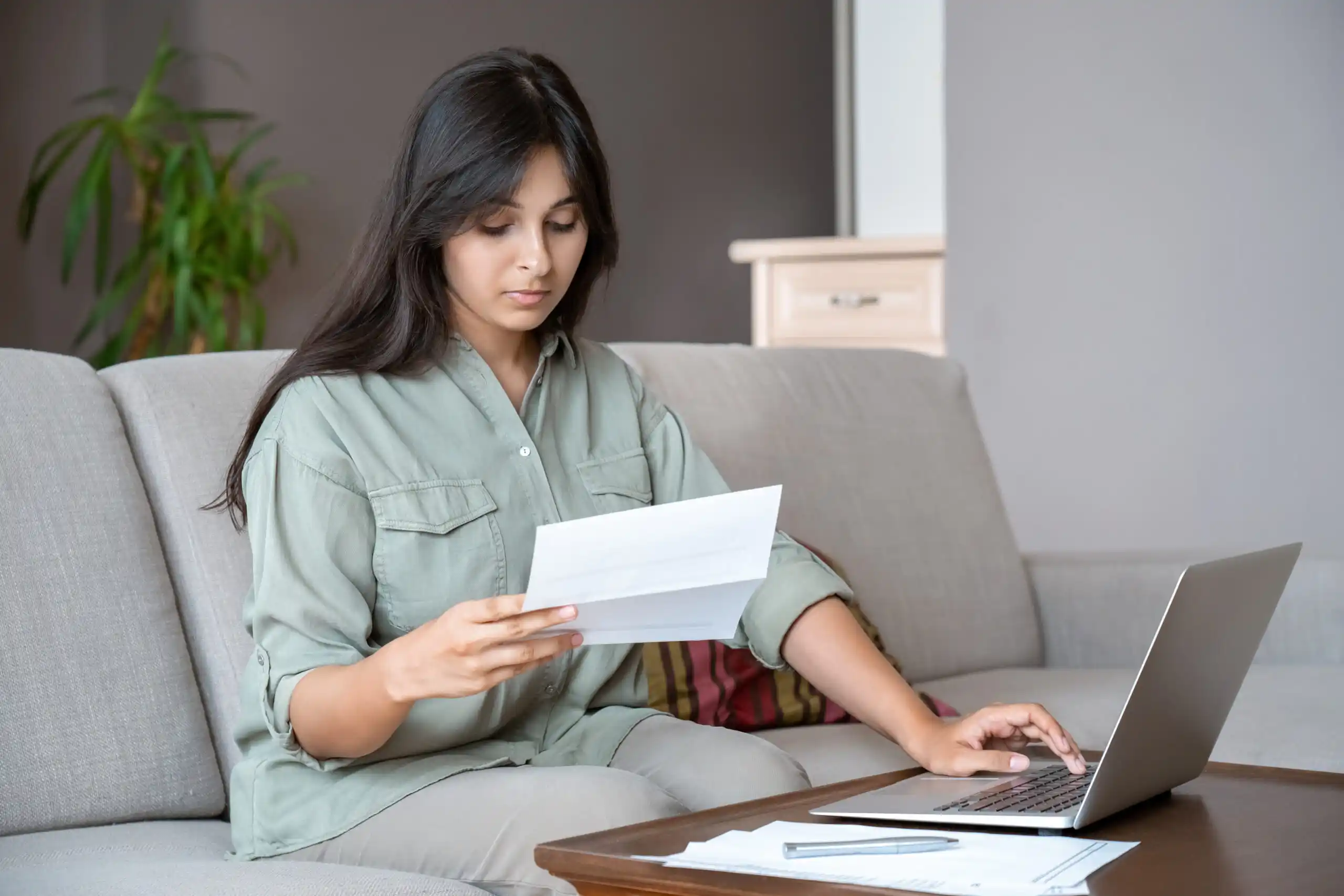 Young woman paying bills