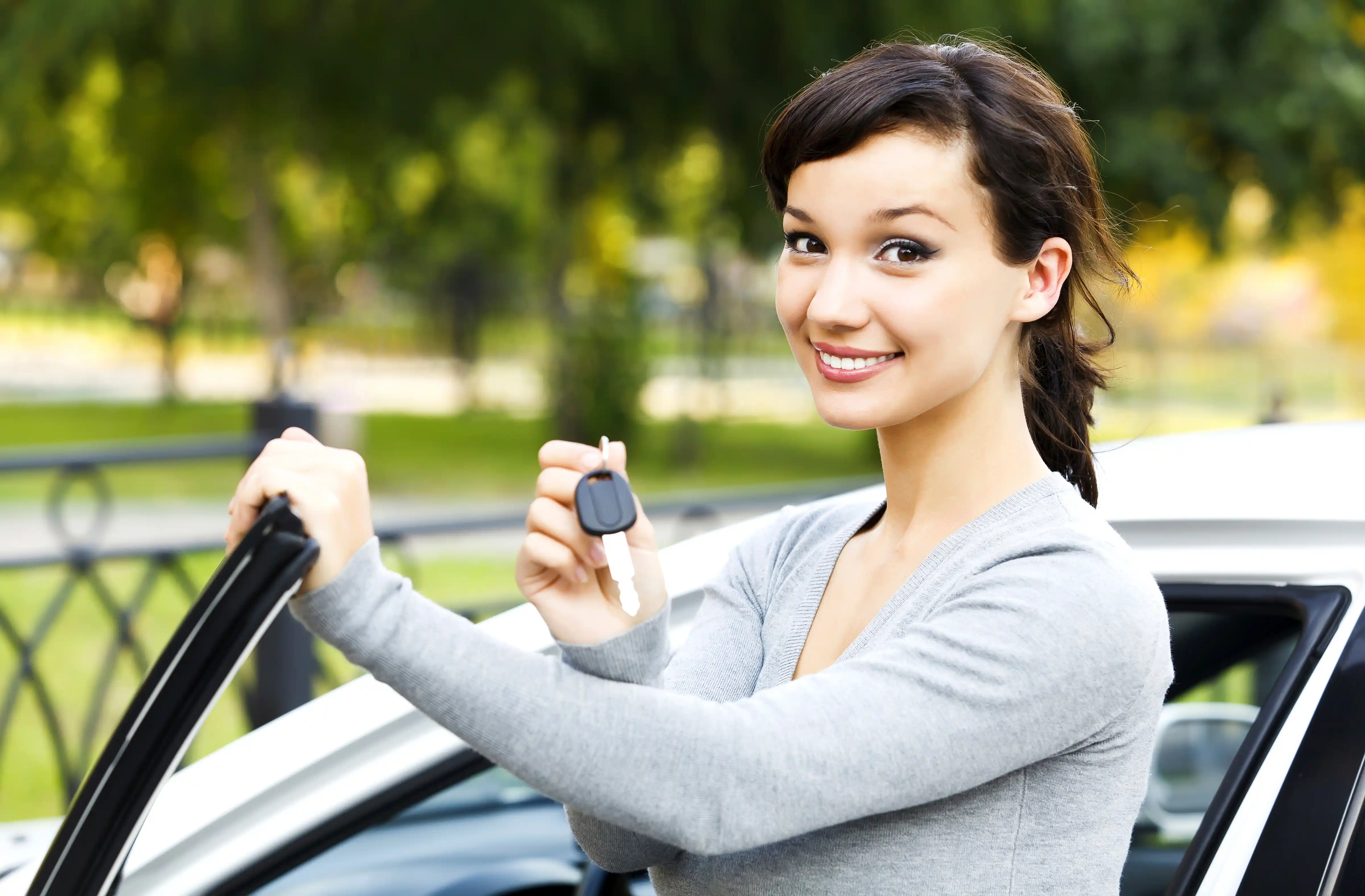 Young woman with a new car