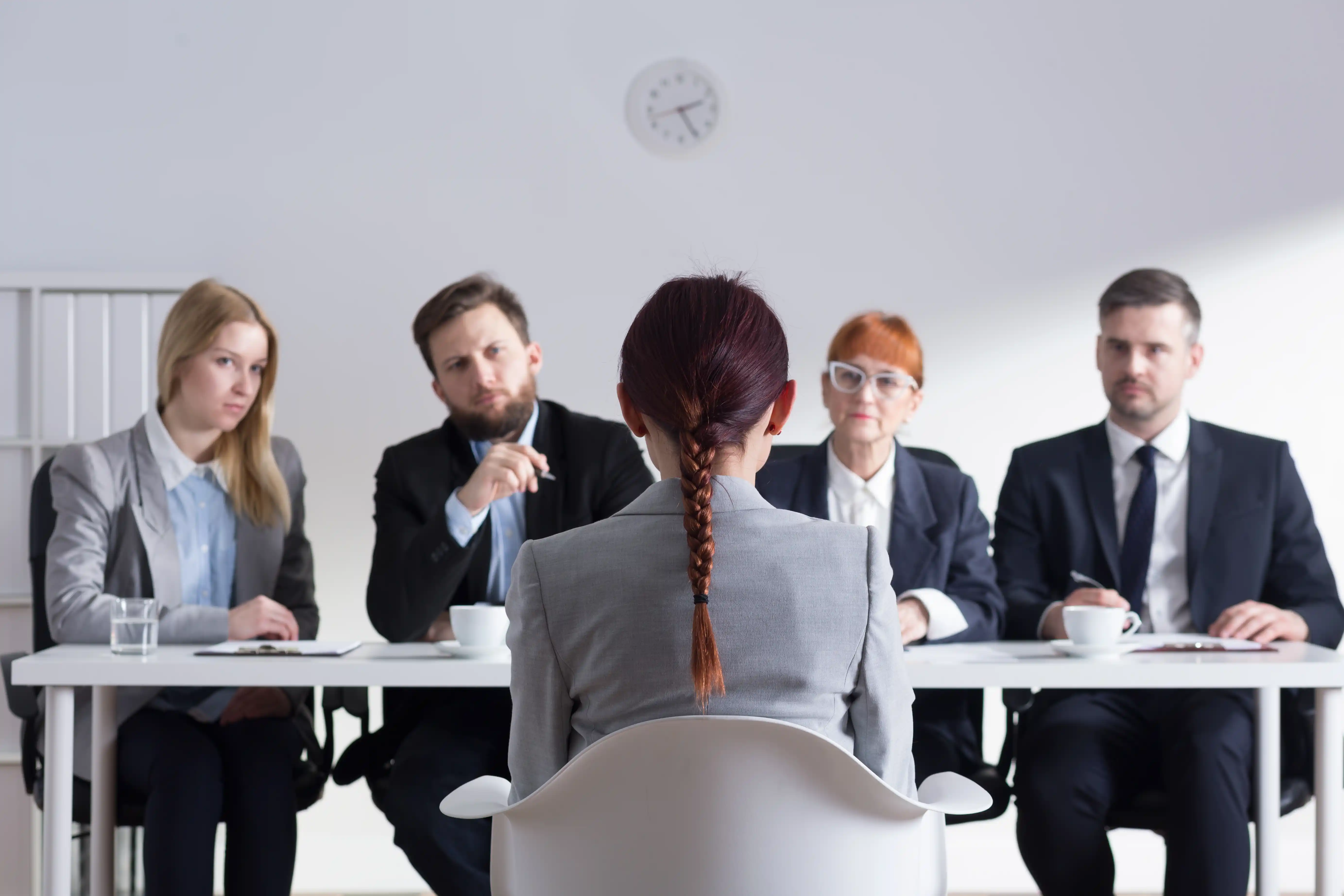 Woman facing hiring committee in job interview 