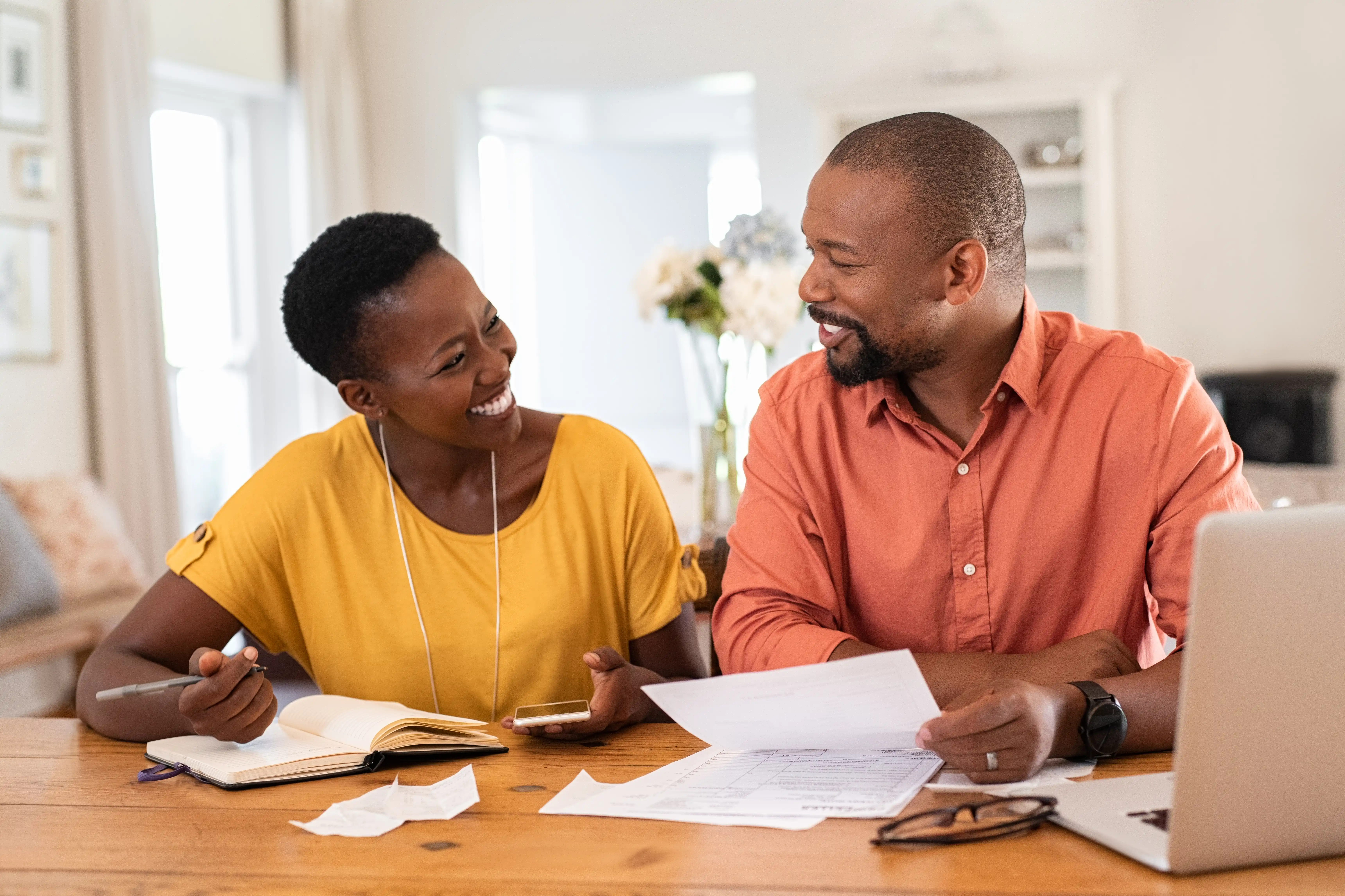 young couple happy about eliminating their debt