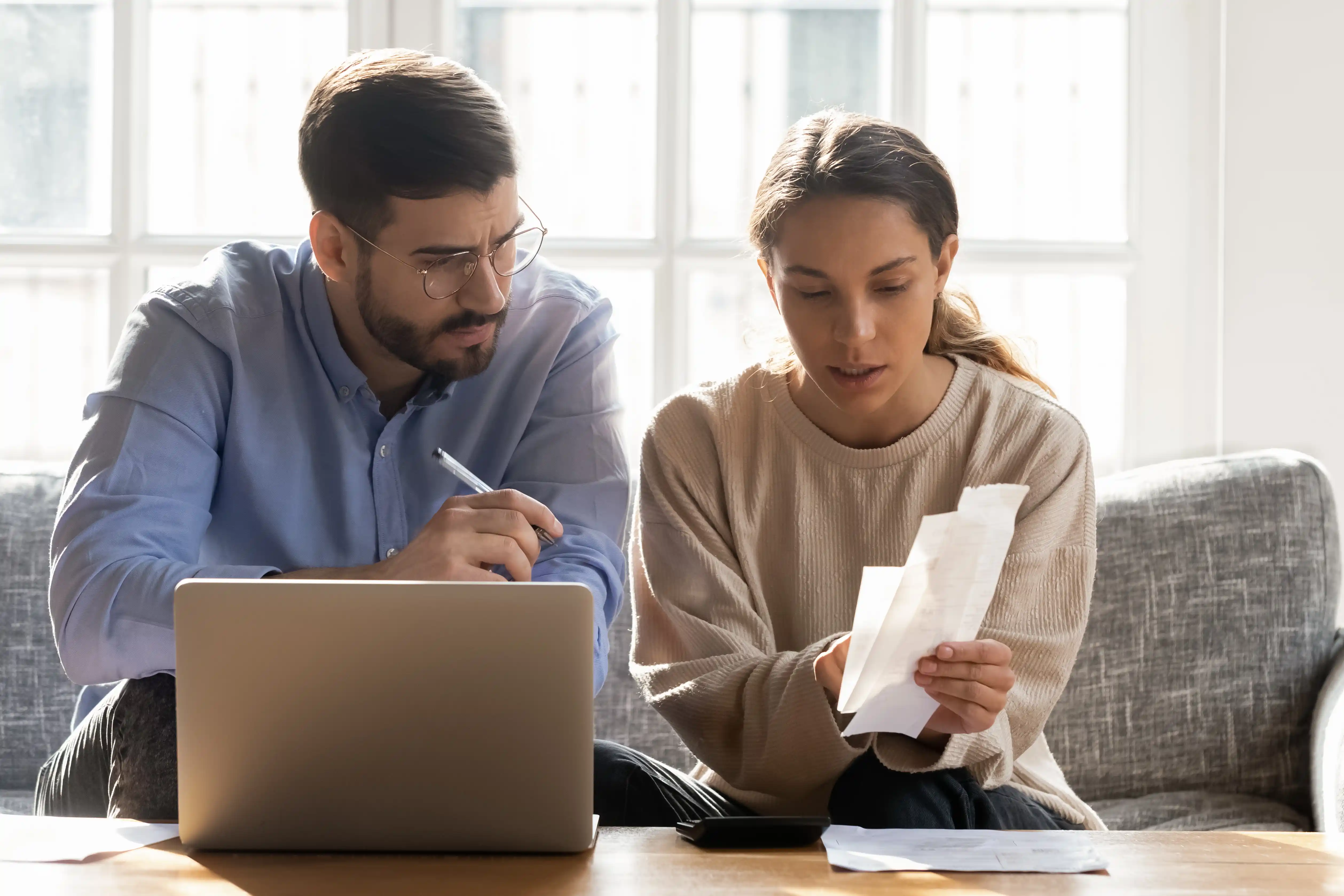 young couple balancing their budget